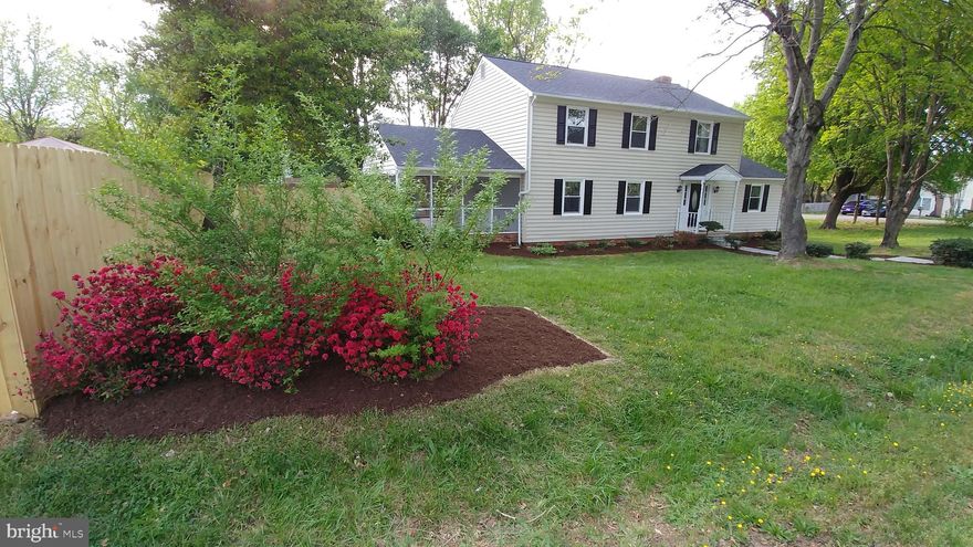 This spacious beauty sits pretty on a corner lot. 5 bedrooms, one is on the main level with it's own full bath. Perfect for the extended family! Hardwood floors on the main level, huge family room with wood burning brick fireplace right off kitchen. Kitchen has granite, stainless steel, passthrough to family room. Family room has lots of windows with backyard view. There is lots of room in this home to spread out. Upstairs is a nice sized master bedroom and updated bath, plus 3 additional big bedrooms,and another full bath. The master bath has been updated with a double sink, tiled floor, and tiled shower/tub. All new upgraded carpet. Huge screened in porch entire length of side of home. The entire backyard is fenced and there are lots of flowering bushes and perennials galore! New roof. This is a very nice corner lot and you can walk to the commuter lot from here in 2 minutes. Close to shopping and 95! No hoa. Shed "as is"