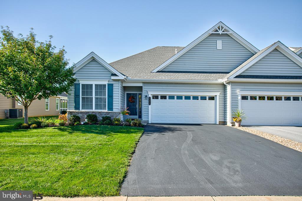 55+ Lifestyle Community. Heated Pool w/ waterfall, Tennis Courts, Walking Paths & Bocce Ball. An amazing Liberty Hill, 3 bedroom & 3 bath, Premium end unit w/ oversized windows featuring natural light throughout the 1st floor. Hardwood flooring in most of the 1st floor w/ soaring ceilings, fireplace in living room & open floor plan. Chef's kitchen w/ huge island, granite countertops, stainless steel appliances & tons of cabinets for storage. Bright sunroom w/ sliders to the oversized paver patio. 1st floor laundry, tankless water heater, water softener, & spacious utility/storage area. Liberty Hill features a magnificent clubhouse & lifestyle center w/ a lifestyle director & concierge service, library, bar area, media room, whirlpool bath, fitness & aerobic rooms, massage & wellness rooms, on-site Olli classes, & lifestyle-health courses at clubhouse. Day & night activities/ monthly calendar published. Every Friday 5- 7 happy hour. Friendly Neighbors!