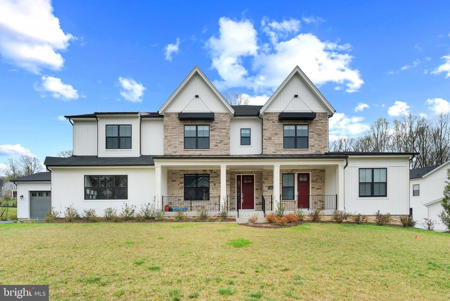 Welcome to this breathtaking contemporary masterpiece, where grand-scale entertaining and modern functionality meet in a seamless blend of luxury and comfort. From the moment you arrive, the home’s unique architectural versatility is on display, highlighted by a rare, self-contained in-law suite located on the main level. This true multi-generational sanctuary features its own private entrance directly from the front porch, offering unparalleled accessibility and independence for guests or extended family. Inside the main residence, you are greeted by a dramatic great room with soaring double-height ceilings and a floor-to-ceiling wall of windows that floods the space with natural light. The heart of the home is a gourmet chef’s kitchen anchored by an expansive quartz waterfall island and professional-grade appliances, including a six-burner gas range and double wall ovens. For the ultimate host, a sophisticated butler’s kitchen and prep area serves as a secondary staging space, flowing into a massive walk-in pantry with custom shelving.

The indoor-outdoor flow is handled with masterful design, leading you from the kitchen to a magnificent covered deck that serves as a year-round retreat. This outdoor living room features high-end wood-plank ceilings and is fully outfitted with motorized retractable screens, allowing you to create an enclosed, insect-free environment at the touch of a button. Beyond the deck, the luxury continues on a custom, oversized stone paver patio. A built-in stone gas fire pit serves as the focal point for evening gatherings, all set against a tranquil, professionally landscaped yard.

The upper level is a dedicated haven of rest, led by a magnificent primary suite characterized by elegant tray ceilings and expansive proportions. The spa-inspired ensuite bathroom is a masterclass in luxury, featuring a deep freestanding soaking tub, an oversized frameless glass-enclosed shower with rainfall hardware, and a double vanity with premium stone countertops. The home’s versatility extends further to the expansive finished basement, which provides an incredible secondary living space. While not the primary in-law suite, this level is fully equipped with an additional guest bedroom and full bathroom, making it perfect for a home theater, gym, or older children.

No detail has been overlooked in the home’s high-tech infrastructure. The pristine garage is ready for the future with high-voltage EV charging capabilities, while the mechanical systems are top-of-the-line. With premium finishes at every turn, this estate is a rare find that offers a truly turnkey, luxury lifestyle in a sophisticated setting.