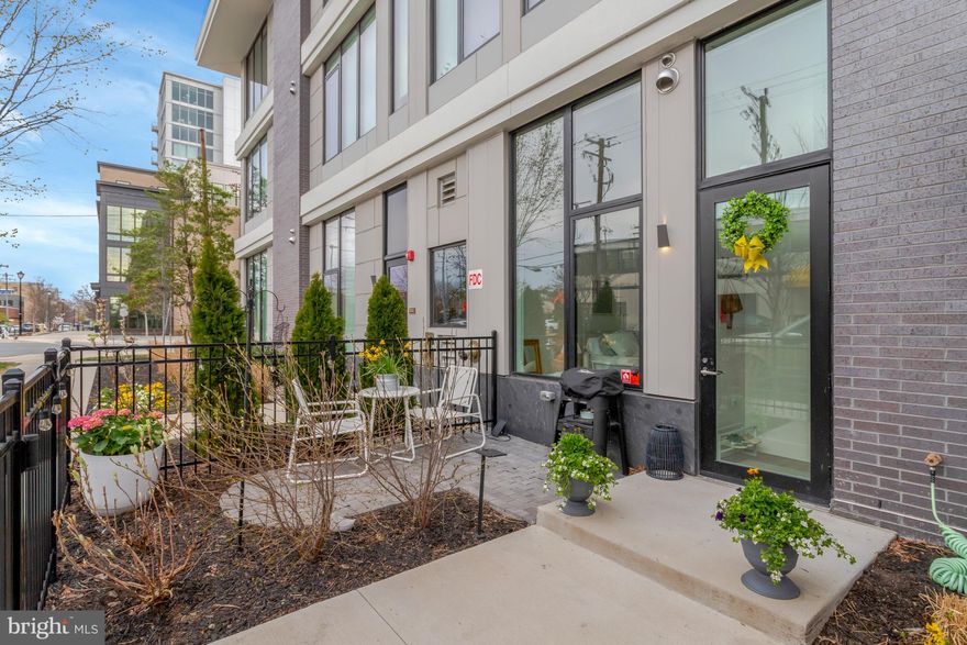 Welcome to 801 North Fairfax Street, Unit 136, an elegant urban oasis in the heart of Alexandria. This modern 793-square foot 1 bed + den condominium offers a sophisticated lifestyle with its sleek design and smart layout complete with plenty of thoughtful storage. The inviting living area, bathed in natural light, seamlessly connects to a large contemporary kitchen equipped with high-end stainless steel appliances, stylish cabinetry, and ample counter space perfect for an aspiring home chef. The spacious primary bedroom provides a serene retreat, complemented by a custom walk-in closet and deep window seat with storage, a well-appointed bathroom featuring chic finishes, and in-unit laundry. The cozy den offers space to accommodate guests, a home office, and/or workout area, along with additional closet organization. Step outside to your private walk-out patio, perfect for entertaining, gardening, and accommodating four-legged friends. With direct street access, convenience is at your doorstep. The building's rooftop deck offers stunning water views, built-in electric grills, and lounge areas, making it an ideal spot for watching fireworks and gathering with friends. Dedicated parking space located in adjacent covered garage - a true commodity in Old Town!  Exclusive-use storage unit conveniently located on the second floor. Experience the vibrant locale, with a variety of dining, shopping, and cultural experiences nearby. Easy access to King Street, Metro, commuter routes, and bike trails. Discover a perfect blend of comfort and style at this exceptional address and enjoy all that Old Town North has to offer.