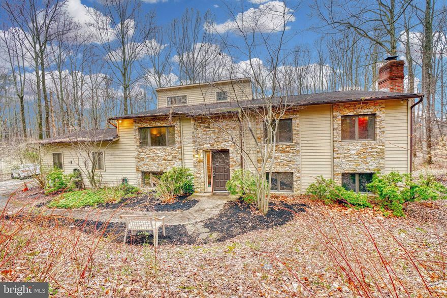 Come enjoy this beautiful, secluded and almost 6 acre property in an excellent location in Reisterstown! If you're looking for privacy this is the property for you. The home has a long driveway and is completely surrounded by trees with plenty of cleared area in the rear of the home. This is a gem of a property and hard to find for under $500k! Sit on your back deck in the morning with your coffee and enjoy all the sights and sounds of nature. This large split foyer is over 3000 total sq feet with a two car side loading garage. Bring your handyman hat and make this property your dream home! This home offers plenty of room on the main level and basement for entertaining. You can access the back deck through the kitchen and master bedroom. This home offers 4 bedrooms and 3 full bathrooms with tall ceilings in the kitchen and dining room.  The heat pump/AC unit is only about 2.5 years old. Property is being sold as-is. You do not want to miss out. Make an appointment today!