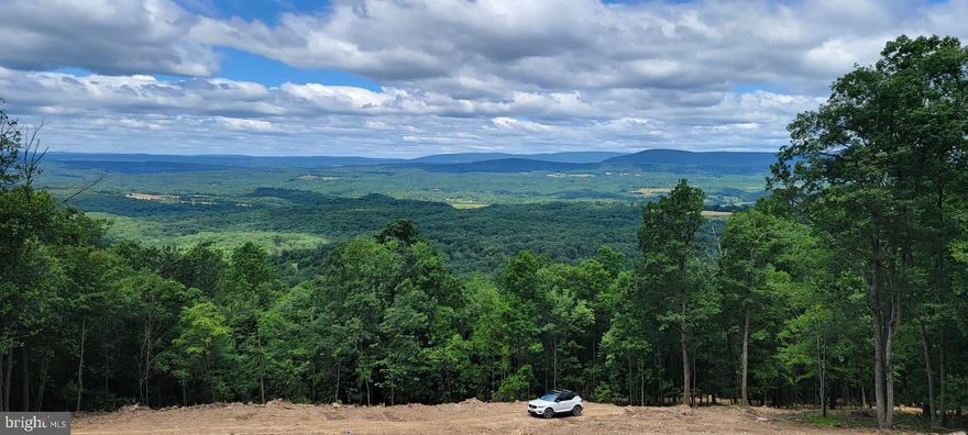 Ready to Build - Two lots totaling 33+ acres with site preparation completed.  The Views are spectacular!  Location is commuter friendly and close to many amenities of the Eastern Panhandle area.  The driveway is established including constructed drainage, electrical conduit and cable have been buried ready for electric connection, the house site is cleared, and the septic is constructed.  Imagine your piece of heaven with the home of your dreams.  Privacy and serenity, beautiful hardwoods with a variety of trees, rock formations and an abundance of wildlife. Community is Equestrian friendly if suitable facilities and proper fencing installed. So many opportunities to create a serene majestic homestead surrounded by nature and breathtaking views! (SEE PHOTOS of concept home provided by sellers - fits the land perfectly!)