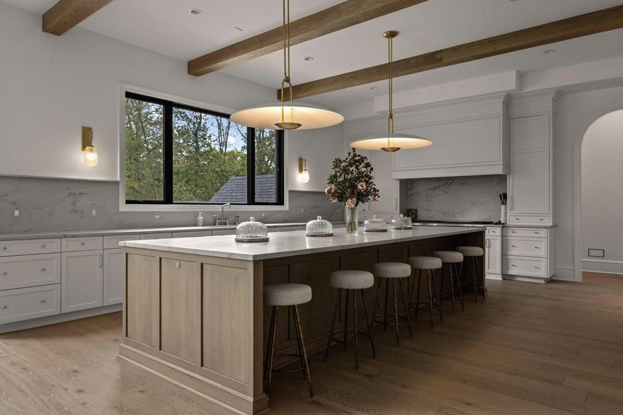 Crafted with uncompromising attention to detail, this extraordinary new construction estate by Lavenir Custom Homes with interiors thoughtfully curated by Boxwood Living - stands as a refined masterpiece of architectural elegance.

Set on 1.46 private acres and spanning 11,471 square feet, the residence is introduced by a striking façade of light-toned stone and brick, a custom-designed drive, and a lantern-lit front portico that establishes an immediate tone of timeless sophistication.

Inside, a dramatic 22-foot foyer and architecturally sculpted curved floating staircase create a breathtaking first impression. The main level flows through refined yet inviting spaces: an elegant sitting room bathed in natural light, a formal dining room elevated by bespoke millwork, and an expansive great room framed by floor-to-ceiling windows that embrace serene views of the manicured grounds.

At the heart of the home, the show kitchen by Lobkovich showcases a commanding 14-foot rift-cut white oak island, fully paneled appliances, a discreet secondary prep kitchen, and a generous walk-in pantry - equally suited for everyday living and grand-scale entertaining.

Upstairs, the luxurious primary suite offers a private balcony, a spa-inspired marble bath with dual vanities and soaking tub, and generous custom walk-in closets. Four additional bedroom suites provide exceptional privacy and comfort, each with ensuite baths and tailored closets.

The lower level elevates leisure and wellness with a temperature-controlled wine cellar, full gym with sauna and steam shower, intimate theater, fireside lounge, and fully appointed wet bar - ideal for unwinding or hosting with ease.

Outdoors, the experience rivals that of a boutique resort. A serene setback pool and spa anchor the property, complemented by a beautifully appointed pool house and covered patio with fireplace and shiplap ceiling, designed for effortless year-round enjoyment

A four-car garage and professionally curated landscaping by Wheat’s Landscape complete the estate. A rare fusion of exquisite craftsmanship, refined interiors, and resort-inspired amenities, this residence stands as a statement of enduring elegance and distinction.

Welcome to 8634 Overlook.