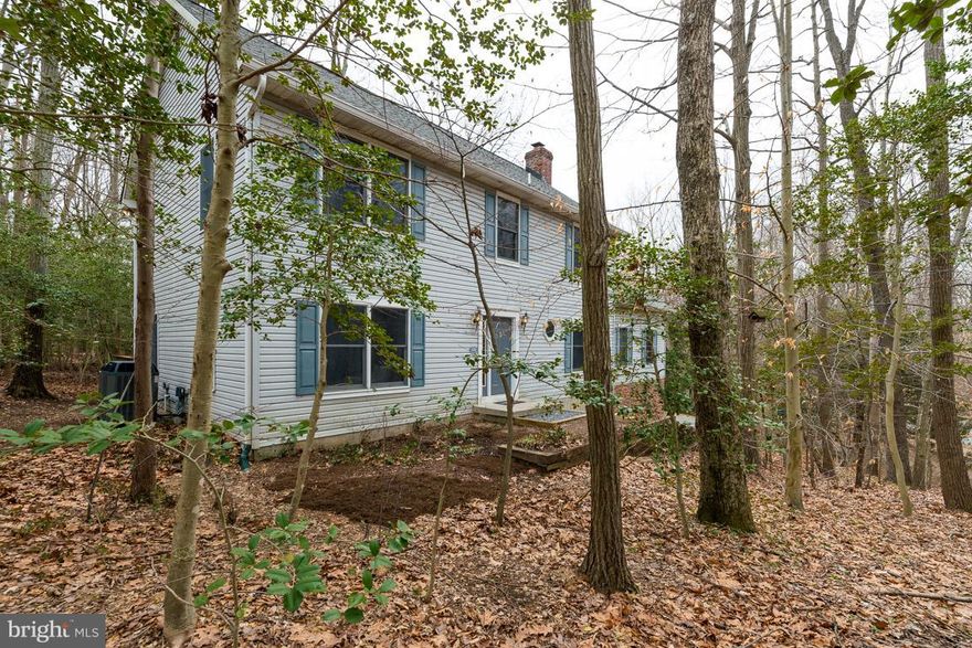 Open Houses Saturday and Sunday!!! Expansive home nestled in the trees on private homesite with seasonal waterviews in water privileged Withernsea.  This home is deceivingly large with 4 BR, main level den, possible 5th BR attic area, huge unfinished basement with 9ft+/- ceilings, living and dining room and great room!  Updated open island kitchen make this the ideal entertaining space.