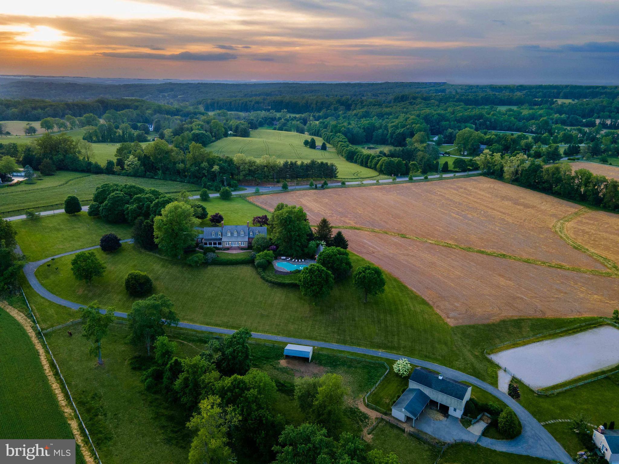Live authentically. Glorious 50 acre farm. Timeless brick Tidewater estate in the heart of My Lady's Manor. Relish the long tree-lined drive and sense of arrival. Georgian classic proportions throughout. Inviting screened in porch made for living. Glass runs the entire length of the house for sublime views all year round. Bring the outside in. Sparkling pool and generous outdoor living spaces to enjoy every last minute of the summer sunsets overlooking the epic vistas in the distance that are yours. Seven stall barn and riding ring, equipment building. Tenant house has three bedrooms and one bathroom for hosting short or long-term guests. Prime Elkridge-Harford locale. Zippy access to Manor Tavern, Inverness Brewery, and Ladew Gardens. See 16425 Old York Rd listing. This property can be purchased with 10.45 acres at $1,700,000, or with additional non-density pasture 39.55 acres for $1,950,000. Property cannot be subdivided. No main dwelling is permitted on the 39.55 acres. The art of uniting human and home.