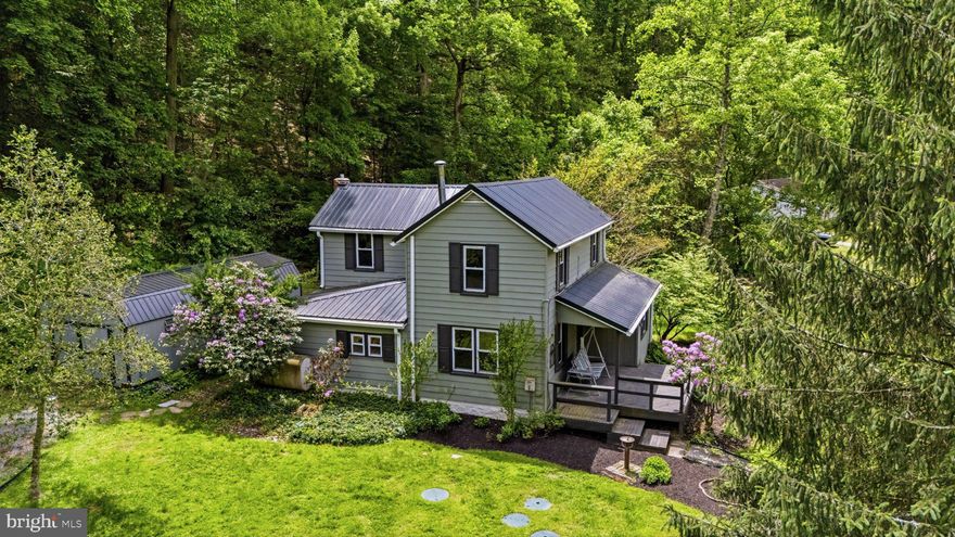 Tucked away down a private lane beneath a welcoming stone arch, this one-of-a-kind property offers a peaceful retreat surrounded by nature and beauty in every direction. Set against rolling hills with flowing water nearby, this private oasis feels worlds away while still remaining conveniently close to local towns, markets, restaurants, and the Chesapeake Bay region.

Enjoy quiet mornings from the front porch swing, afternoons watching bald eagles soar overhead, and evenings filled with wildlife sightings including foxes, deer, herons, hummingbirds, hawks, and countless bird species. Large windows throughout the home perfectly frame the changing seasons, sunset views, and the tranquil landscape beyond.

Perfect for nature lovers, gardeners, homesteaders, or anyone dreaming of a more intentional lifestyle, the property features an incredible variety of established edible and native plantings including apple trees, pawpaws, cherries, figs, hazelnuts, blueberries, grapes, gooseberries, mulberries, and more. There is ample space for gardening, farming, chickens, beekeeping, creative ventures, or simply enjoying the serenity of your own private sanctuary.

Recent updates include a new metal roof, updated septic system, new boiler and a new oven, offering added peace of mind while preserving the charm and character of the property.

Whether you envision peaceful country living, a hobby farm, a wellness retreat, or a creative business opportunity, this special property offers endless possibilities in a truly magical setting at 36 Mayse Ln.