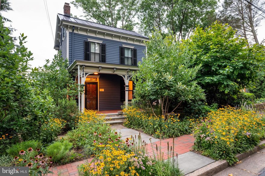 A JEWEL in the heart of Historic Doylestown Borough!  A rare find—a spacious and private lot with a 2-car garage AND barn studio.  The "Charles Hart" home--a 3bdrm/1.5 Bath Victorian has graced the corner of Lafayette and Oakland for more than 140 years, a landmark of classic architecture and enduring charm. Exquisitely updated with high-end finishes and design throughout, it blends history with modern comfort. With its front porch and timeless swing, this home invites you to linger under the shade of magnolias and thoughtfully planted native gardens. Step through what is believed to be the home’s original Front Door, complete with its charming mail slot, and into a welcoming Foyer. Here, warm pumpkin-pine floors, lofty ceilings, and a glimpse straight through to the side screened-in porch set the tone for the home’s inviting character. The Living Room features built-in walnut shelving and a Serge Mouille ceiling lamp--a sought after mid century modern design fixture. An exquisite, custom-designed Kitchen is wrapped in Statuary marble — countertops, backsplash, and island — with streamlined Canaan cabinetry, premium "Smeg" appliances, discreet Bocci outlets, and a Built-In coffee nook. The light-filled Dining Room features a new Built-in Bench, a sweet scalloped edge chandelier, crisp white paint and VIEWS of your LUSH backyard.  Step out onto your Brazilian Ipe Wood Deck with your morning coffee and enjoy the privacy and quiet! Upstairs, you'll find the Primary Bedroom in the front of the home.  Across the hall, be delighted by the long, walk-in closet that you seldom find in Historic Homes!  The Exquisite FULL Bath features Carrara  Marble throughout with soaking tub/shower and custom designed wall hung vanity with rare Santos Rosewood. ***Look for the hidden medicine cabinet!  A 2nd Bedroom completes the second floor. The 3rd Floor features another bedroom with walk-in closet and painted wood floors. The Finished Basement has the Laundry Room, a Powder Room and space for a workout Room, office or storage. One of this home’s most enchanting features is its lush, thoughtfully designed landscape. Created by Indigenous Ingenuities, the native perennial gardens showcase graceful River Birch trees, pathways lined with white hydrangeas, and two magnificent oak hydrangeas—all embraced by a striking horizontal Ipe Brazilian wood fence! The bluestone pathway lined by hydrangeas leads to the Barn with the Two Car Garage and paver driveway. Native prickly pear cactus line the driveway with gorgeous yellow blooms in the springtime! Above the garage, a bright and airy space with painted white walls and built-in bookshelves awaits—a perfect studio, writing nook, or guest retreat with heat and electricity!  Updates include metal standing seam roofs on both the house and barn (2020), compact hi-efficiency Bosch Tankless gas heat/hot Water and "Runtal" baseboard heating system. Premiere location-- Walk to everything the borough has to offer...the Farmer's Market, the bookstore, the museums, the shoppes! This is THAT home you've admired for years--it's time to move into the Borough! Showings begin on September 26th.