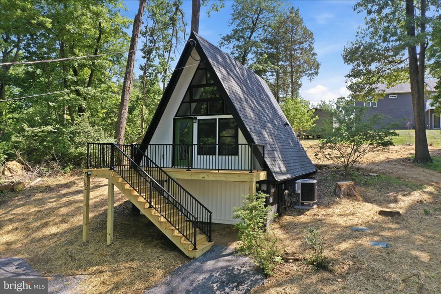 Escape the ordinary and disappear into the trees. Tucked away in a serene, wooded clearing, this fully renovated 1970s A-frame offers the perfect blend of nostalgic charm and modern luxury. Featuring a dramatic floor-to-ceiling windows, this cabin fills with warm natural light by day and starlight by night. Enjoy your morning coffee on the brand-new private patio, listen to the sounds of nature, or curl up with a book in the lofted bedroom. Whether it's a romantic getaway or a solo creative retreat, this tiny sanctuary offers privacy without sacrificing comfort.

A list of updates:
-Septic system pumped, updated, and inspected (report in documents)
-Completely new HVAC system including duct work
-﻿﻿New hot water heater
-Crawlspace updated from vented to encapsulated
- ﻿﻿Driveway updated and expanded with more parking 

- New GE 2.4-cu ft. Washer/Dryer combo
- New Samsung stove/range
- ﻿﻿New Midea dishwasher and fridge
- New Oak stairs and handrail
⁃New outlets and switches
⁃New light fixtures throughout
⁃New roof with Certainteed architectural shingles
⁃New gutters and downspouts
⁃﻿﻿New siding
- New LVP flooring 
⁃New windows
⁃New exterior and interior doors
⁃New deck
⁃﻿﻿New stamped patio
⁃New cabinets and countertop
⁃New toilet 
⁃New tub and shower combo
⁃New vanity
- New paint throughout