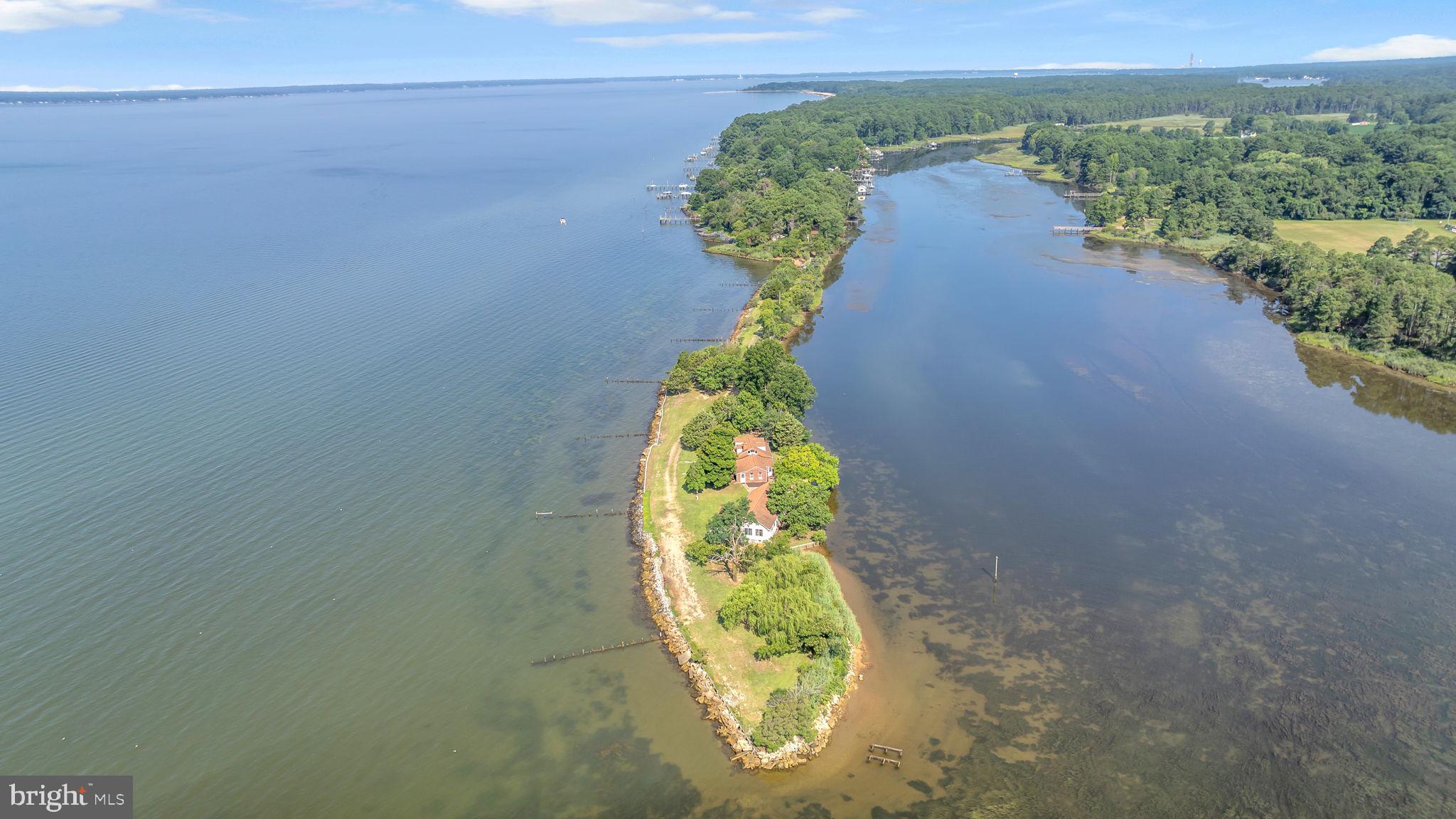 Exceptional Waterfront Retreat! Discover one of the most unique and rare properties in Charles County, a stunning paradise nestled on 2.7 acres situated on your own private peninsula. This unique property offers approximately 1,800 feet of waterfront, providing breathtaking sunsets over the Potomac River plus sunrises over Neale Sound, truly the best of both worlds for water enthusiasts and nature lovers alike. For hunters and sportsmen, the property features three licensed duck blind sites and a private boat ramp perfectly positioned to enhance your hunting and fishing experiences, or enjoy crabbing, boating, kayaking, and jet skiing amidst the natural beauty of this extraordinary setting. The charming Cape Cod-style home boasts panoramic views from every window, showcasing the one of a kind waterfront vistas. Inside, you'll find carefully curated touches that blend comfort with functionality, including radiant floor heating, creating an inviting and serene living environment. Additional highlights include a spacious 52 x 32 detached garage and workshop, complete with electric service, a mini split wall system, and a 200-amp electrical panel, ideal for hobbyists, collectors, or storage for your hunting gear and water toys! If you’re seeking a peaceful sanctuary with modern conveniences just moments away, this one-of-a-kind oasis is your perfect match. Located conveniently close to Swan Point, where you can enjoy a round of golf or seafood dinner at the Yacht Club, and an added bonus of free 4th of July fireworks over the water from Cobb Island or Colonial Beach, Va, all locales just a short boat ride away. This property truly offers the best of waterfront living and privacy. Don’t miss this rare opportunity!