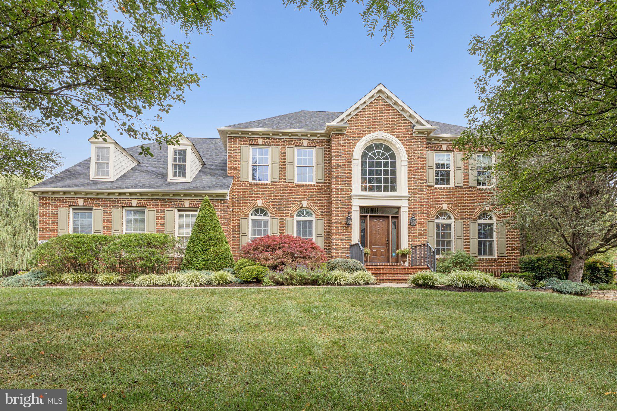 Welcome to 3028 Seneca Chief Trail in Ellicott City, a beautiful NV Homes Georgetown model offering 7,034 total square feet of living space, including a mostly finished basement, set on nearly one acre of wooded privacy. This home has been lovingly maintained by the original owners and showcases thoughtful updates throughout.
The main level impresses with soaring ceilings and a double staircase that flows from both the foyer and the kitchen. The gourmet kitchen was renovated in 2018 with quartz counters, white cabinetry, and stainless steel appliances, and opens seamlessly into the sunroom and spacious family room, making it perfect for entertaining. Off the sunroom, the backyard features a Trex deck completed in 2023 and back pavers installed in 2022. The main level also includes a large living room, dining room, private office with serene lawn views, laundry room, and a freshly carpeted family room featuring built-ins and a fireplace.
Upstairs offers four generously sized bedrooms. The primary suite includes a sitting room, two walk-in closets, and a large bath. A Jack and Jill suite connects two bedrooms with a shared bath, while the fourth bedroom has its own private bath. New carpet was just installed throughout the entire upstairs.
The walkout basement expands the living space with a large media room, a flex room with adjoining full bath, a unique custom-designed make-up/hair studio, and an unfinished storage and utility space with built-in cabinetry.
Additional highlights include a two-car garage with direct access to the laundry room, a driveway that accommodates five or more cars, a roof replaced three years ago with transferable warranty, two separate HVAC systems (furnace/AC for the main level and basement, heat pump for the upper level), nearly all fresh interior paint, and a washer and dryer that are only a couple of years old.
This home combines elegance, space, and privacy, all within a highly desirable Ellicott City location. It feeds into Manor Woods Elementary, Mount View Middle School, and Marriotts Ridge High School. Open houses will be held Saturday and Sunday. Square footage is based on estimated floor plans provided by the photographer and may differ from public records. All measurements are approximate and should be independently verified.