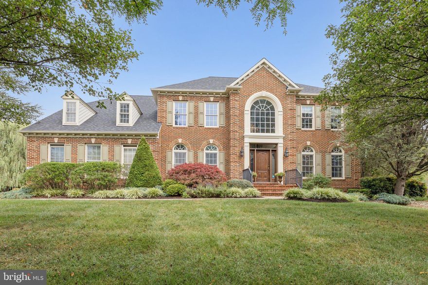 Welcome to 3028 Seneca Chief Trail in Ellicott City, a beautiful NV Homes Georgetown model offering 7,034 total square feet of living space, including a mostly finished basement, set on nearly one acre of wooded privacy. This home has been lovingly maintained by the original owners and showcases thoughtful updates throughout.

The main level impresses with soaring ceilings and a double staircase that flows from both the foyer and the kitchen. The gourmet kitchen was renovated in 2018 with quartz counters, white cabinetry, and stainless steel appliances, and opens seamlessly into the sunroom and spacious family room, making it perfect for entertaining. Off the sunroom, the backyard features a Trex deck completed in 2023 and back pavers installed in 2022. The main level also includes a large living room, dining room, private office with serene lawn views, laundry room, and a freshly carpeted family room featuring built-ins and a fireplace.

Upstairs offers four generously sized bedrooms. The primary suite includes a sitting room, two walk-in closets, and a large bath. A Jack and Jill suite connects two bedrooms with a shared bath, while the fourth bedroom has its own private bath. New carpet was just installed throughout the entire upstairs.

The walkout basement expands the living space with a large media room, a flex room with adjoining full bath, a unique custom-designed make-up/hair studio, and an unfinished storage and utility space with built-in cabinetry.

Additional highlights include a two-car garage with direct access to the laundry room, a driveway that accommodates five or more cars, a roof replaced three years ago with transferable warranty, two separate HVAC systems (furnace/AC for the main level and basement, heat pump for the upper level), nearly all fresh interior paint, and a washer and dryer that are only a couple of years old.

This home combines elegance, space, and privacy, all within a highly desirable Ellicott City location. It feeds into Manor Woods Elementary, Mount View Middle School, and Marriotts Ridge High School.  Open houses will be held Saturday and Sunday. Square footage is based on estimated floor plans provided by the photographer and may differ from public records. All measurements are approximate and should be independently verified.