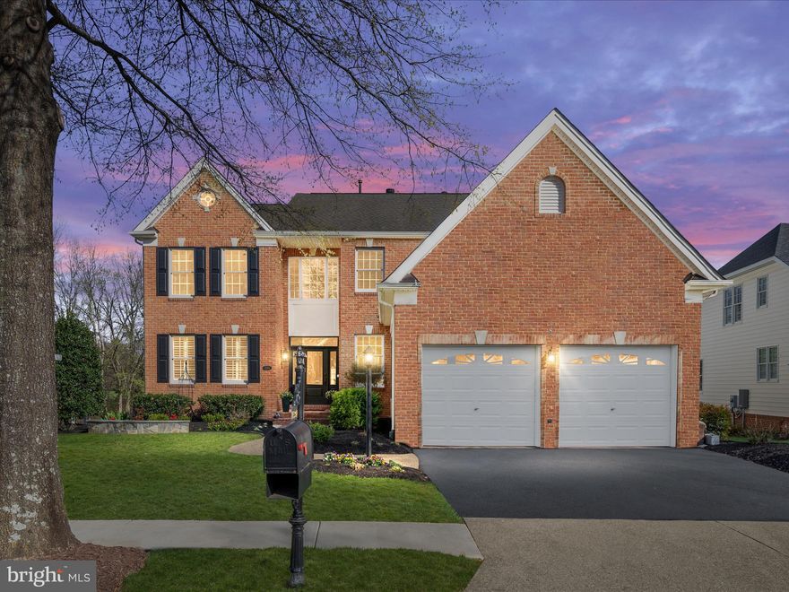 Welcome to 15264 Golf View Dr a stunning residence nestled in the highly sought after Dominion Valley Country Club. Perfectly positioned within walking distance of the golf course, clubhouse, pool, and sports pavilion this home offers an exceptional location with breathtaking views of the Arnold Palmer Signature golf course and a tranquil pond from the backyard, screened porch, and all three levels. This elegant Muirfield model features a highly desirable spacious primary suite complimenting the main level beginning with a grand two-story foyer that showcases a new front door, gleaming hardwood flooring, and wainscoting. Plantation shutters and hardwood floors continue throughout the main level. The beautifully renovated kitchen is a chef’s dream, featuring double-stacked white cabinetry with an espresso island, granite countertops, a BOSCH six-burner range with a vent hood,  farmhouse sink, modern ceramic subway tile backsplash, under-cabinet lighting, and stainless-steel appliances, including a BOSCH counter-depth refrigerator and Miele dishwasher. The kitchen seamlessly flows into the dining room, which boasts a butler’s pantry with stacked cabinetry, granite countertops,  beverage refrigerator, under cabinet lighting, and elegant crown molding. The two-story great room has been beautifully renovated with a center wall removed to enhance natural light streaming through a wall of windows. A stunning raised stacked-stone gas fireplace with a slate mantel and hearth serves as the focal point. The main level also includes a convenient drop zone with cabinetry, granite countertops, and board-and-batten detailing. French doors open from the great room to an impressive screened porch, complete with a stacked-stone exterior wall, a beamed vaulted ceiling with two ceiling fans, privacy shades, and the soothing sounds of the pond fountain. Relax and enjoy serene golf course and pond views! The spacious primary suite on the main level features a bay window sitting area with tranquil views, recessed lighting, plantation shutters, two walk-in closets, and a linen closet. The luxurious primary bathroom offers a spa-like experience with a soaking tub, a large shower, ceramic tile flooring, and a double-sink vanity. An oak staircase with new iron balusters leads to the upper level, where you’ll find two additional spacious bedrooms, each offering ample closet space, plush carpeting, and ceiling fans. A freshly painted loft with built-in shelving and a walk-in closet provides the perfect play area or home office. The upper-level hall bathroom features a tub/shower combination, a double-sink vanity, and a linen closet for added storage. The fully finished walk-out basement is an entertainer’s dream, featuring daylight windows, a spacious recreation area, and a handsome wet bar with wine and beverage refrigerators, granite countertops, and glass-front upper cabinets. A large den with a walk-in closet adds versatility to this expansive lower level. Outdoor living is truly exceptional, with a large Trex deck, a screened porch, and a beautifully designed paver patio with a seating wall. The home’s impressive brick front with a brick water table is complemented by professional landscaping and a wood fence. Additional features include an irrigation system for a lush, well-maintained lawn and a finished two-car garage. Recent updates include a 75-gallon hot water heater (2019), HVAC Zone 1 & 2 (2019), roof (2012) Residents of DVCC enjoy unparalleled resort-style amenities, including a renovated clubhouse, an Arnold Palmer-designed golf course, sports pavilion and fitness center, four resort-style outdoor pools, an indoor pool, tennis and pickleball courts, basketball and sand volleyball courts, scenic walking trails, multiple playgrounds, and stocked fishing pond. Fitness and golf memberships are available. Excellent Schools located within the community. Dont Miss This One!