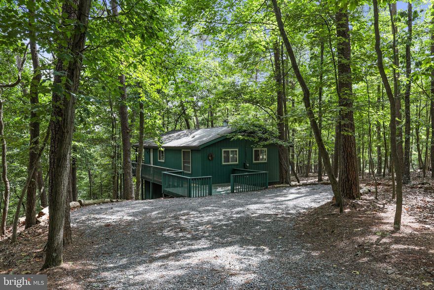 Multiple offers received.  BEST and FINAL offers due by 3:00 PM , August 21, 2023.  Enchanted updated cottage in the treetops! Light filled interior with beautiful wood T&G vaulted ceilings in great room, both bedrooms and new luxury vinyl plank flooring throughout. Gorgeous updated Kraftmaid Maple kitchen cabinets and granite counters. New stainless steel appliances. Open floor plan with free standing gas stove. New MrCool mini split unit in great room. 2 new sliding glass doors in the great room that lead to the 24×8 covered deck to enjoy the outdoors with friends and family. Updated bathroom. Imagine waking up to spectacular views of heavy forest and sounds of nature. The collage sits on 2.17 wooded acres with lots of privacy! All news windows and sliding glass doors in 2017. New 30 year Architectural grade shingles in November 2021. Class B Indoor-Outdoor membership available. Selling furnished, turn key. Everything will convey as of 8/6/23.