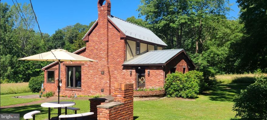 If you are looking for a home with some land, a little distance from town and yet not far from all the conveniences you need, this home is for you.   Drive down the driveway to the house which is situated on 2.95 acres.  The home's main level features a large living room, dining room, kitchen, other room (has been used as a bedroom), and bath.   There's a bedroom on the upper level as well as an unfinished room that could be turned into a bedroom, an office or just used for storage.  The home has replacement windows on the main level including the two picture windows which are tempered glass with UV shield.  The home has a metal roof, baseboard electric heat, and a ductless heat/AC unit.  The property also features an Esh's storage shed, 2-car carport, and root cellar.    Planting a garden next year will be an easy task on the large, level, lower part of the lot.  Don't miss out on this one!  Call today for a showing!