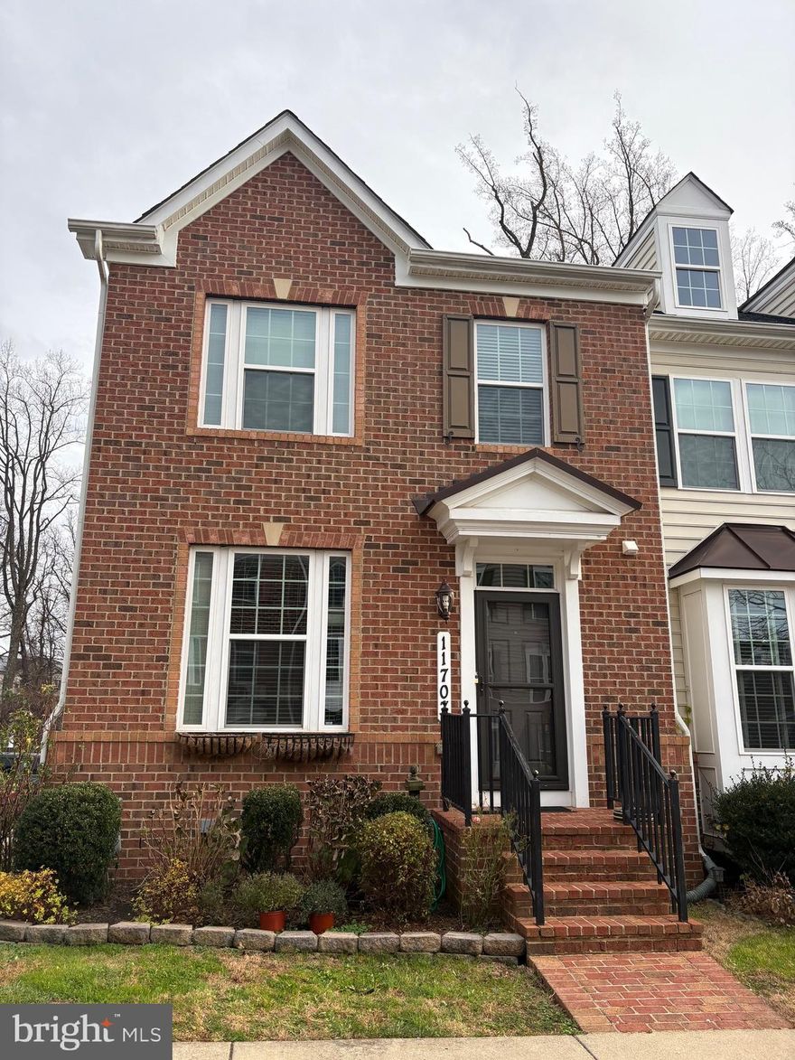 Beautiful brick-front end-unit townhome with 3 BR, 3 Full Bath, 1 half in Clarksburg Village, set on a premium corner lot with a backyard that backs to the woods. Enjoy three fully finished levels filled with natural light, hardwood floors, and a well-appointed kitchen with stainless-steel appliances. The main level opens through French patio doors to a private brick patio—perfect for relaxing or entertaining. Upstairs, the spacious primary suite features a lighted tray ceiling. Walk-out basement adds flexible living space and easy outdoor access. Conveniently located a short distance from parks, the community clubhouse, and shopping, Clarksburg Outlets.   Close to Route 27, I-270.