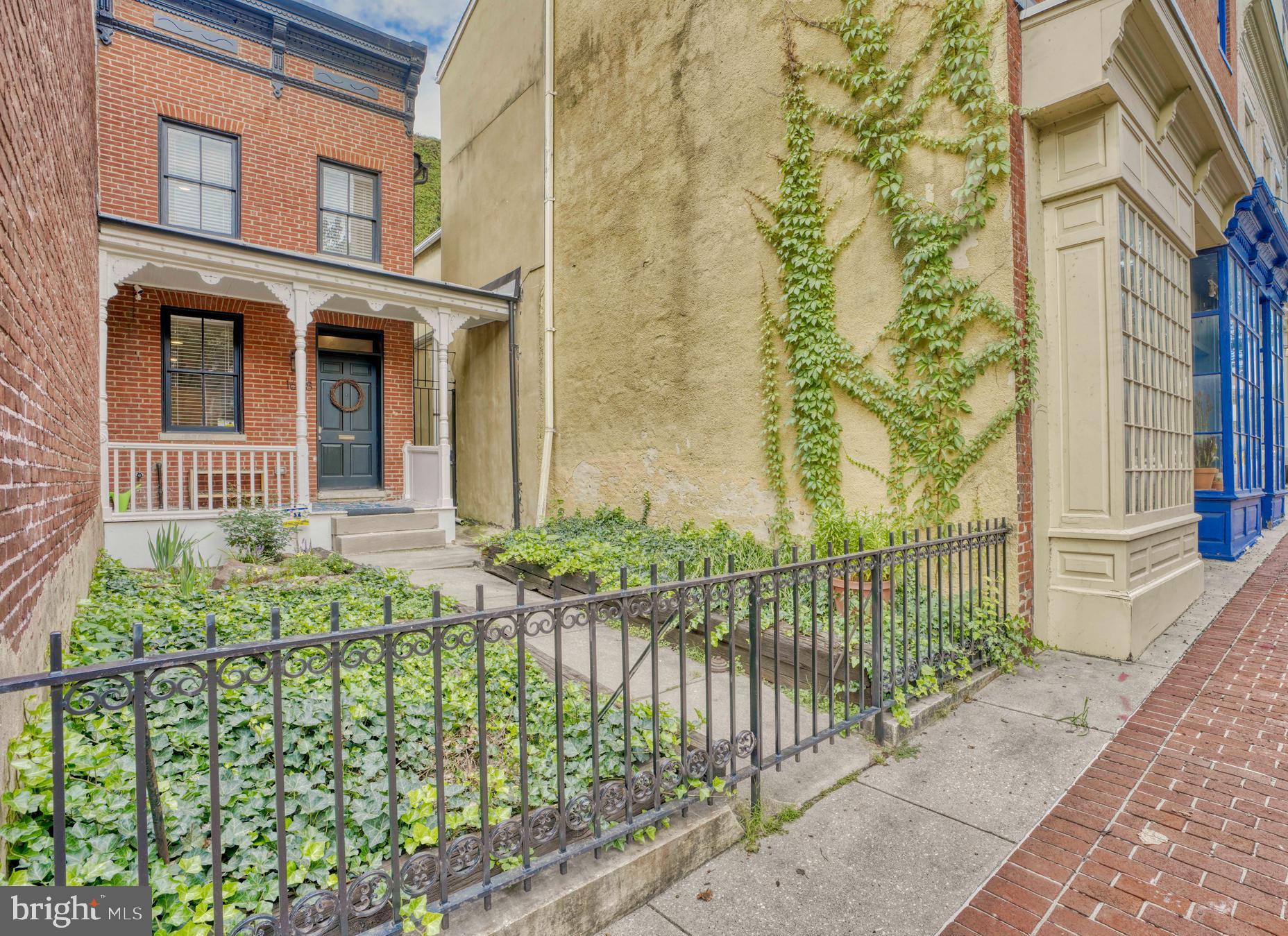 Ready to escape the hustle and bustle in the middle of the hustle and bustle? Check out this oasis in the heart of Upper Fells Point. Enjoy a rare and beautiful front yard with a delightful front porch ready for a rocking chair and cool drink. Yes, you can have a front yard, garden, and more! Step inside to find a gorgeous and recently updated home that still has tons of CHAP credit time left. No touch or finish was missed in bringing this home up to date while maintaining the classic charm. Large open floor plan carries you from the living room - with brick accent wall - to the well appointed eat-in kitchen with custom built cabinetry including a huge pantry. Journey upstairs and you’ll find two large bedrooms with recessed lighting and ceiling fan in primary bedroom. Step outside and continue to be impressed! Large back yard with private gated parking pad for ultimate security and privacy. Primary bedroom leads to a nice quiet deck for morning coffee, with stairs leading to an expansive rooftop deck with million dollar views; great for evenings with friends and entertaining. Freshly updated, CHAP credit, private parking, roof deck… what more could you need? One block from everything Hopkins and moments to Patterson Park and the Fells Point waterfront.