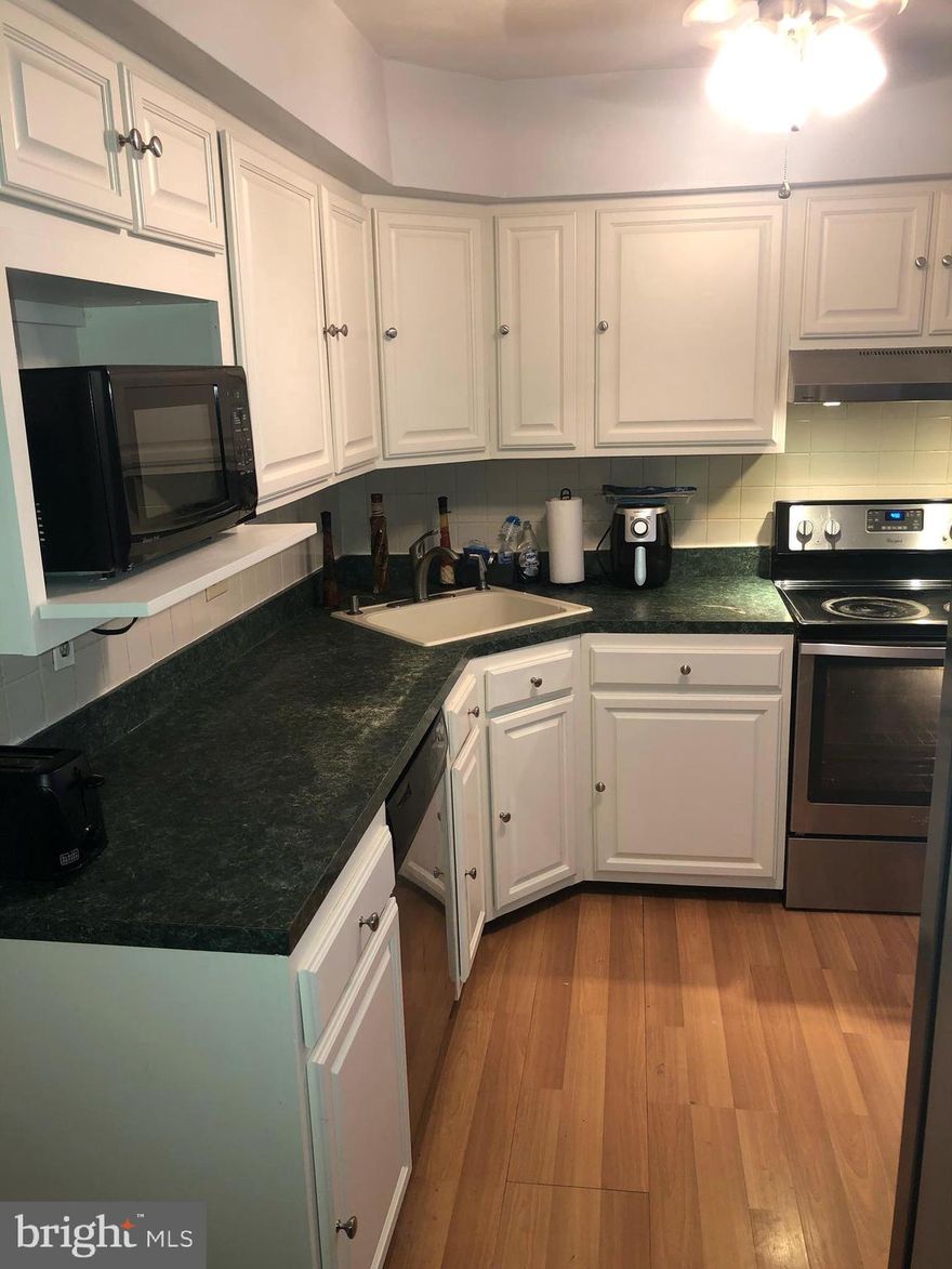 HIGHLY MOTIVATED SELLER - NEW PRICE!  WILL ASSIST WITH CLOSING COSTS.   Will also provide $1000 credit to buyer at closing for upgrades to kitchen counter with an acceptable offer and will remove the fish tank in the bathroom and replace with drywall before closing. Great opportunity to own a nice townhouse with 4 spacious bedrooms that is move in ready.  This home features laminate flooring and new carpeting throughout.  Relax or entertain in the Living/Dining Room combo.  It has all stainless steel appliances and a new refrigerator. Laundry facilities are conveniently located upstairs. Retreat to the large rear yard with privacy fence & enjoy the fall weather or escape to your own oasis if working from home or virtual schooling. All the windows have been replaced except the kitchen windows. New HVAC, freshly painted, and the added amenity of a Ring doorbell.  Parking includes 1 assigned space and there is visitors parking nearby.  Close to shopping, restaurants and subways.  Easy access to Central Ave and I-95.