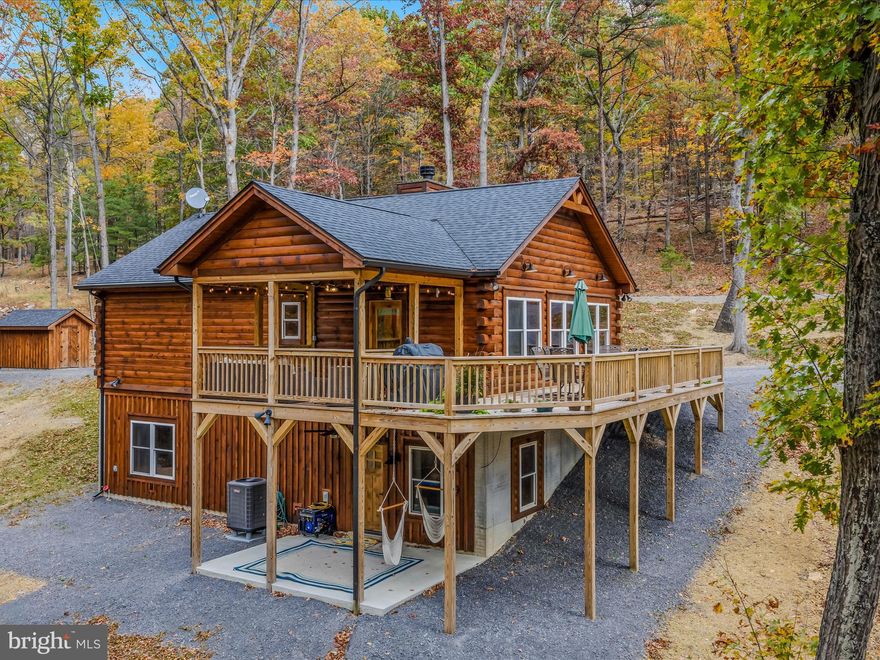 BACK TO ACTIVE DUE TO BUYER PERSONAL ISSUES-NO FAULT OF THE SELLER OR PROPERTY
ALL INSPECTIONS COMPLETE AND AVAILABLE 
Unrestricted Getaway or Your Next Airbnb!
Discover another fabulous home by ALLENHOMES, where craftsmanship and quality meet rustic charm. This country log home offers all the high-end finishes and thoughtful details you’ve come to expect from this highly sought-after builder: soft close cabinets, under cabinet lighting, carbon stainless steel appliances, granite countertops, 10 ft ceilings on lower level, recessed & accent lighting, wood accents throughout.
The main level features a spacious primary bedroom and bath, along with an open-concept kitchen, dining, and living area with cathedral ceilings highlighted by a southern wall of windows that fills the space with natural light. A floor-to-ceiling stone woodburning fireplace creates the perfect cozy centerpiece for relaxing or entertaining.
Step through the glass doors to enjoy the covered porch and deck, ideal for taking in peaceful sunsets through the trees — and when the leaves fall, you’ll love the expanded mountain view!
The entryway provides plenty of space for cubby storage for coats and shoes, while a convenient main-level laundry closet makes daily living easy.
The finished lower level offers two additional bedrooms, a full bath, and an inviting family room that opens to a covered patio area wired for a hot tub. There’s even a generator hookup for peace of mind.
Whether you’re looking for a private retreat, full-time residence, or an income-producing Airbnb, this unrestricted property offers endless possibilities and timeless mountain appeal!