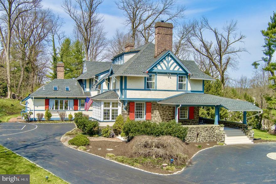 Welcome to this gracious and stately Saint Davids home,  originally named “Eldoun” when it was completed in 1904. Located in one of the most prestigious sections of Radnor Township, stone pillars frame the entrance to this stunning 3 acre property. A majestic stone exterior commands attention as you approach along the driveway, leading to a welcoming wraparound porch, ideal for enjoying the outdoors year-round while overlooking the beautiful grounds which include a detached garage which once served as a carriage house. Throughout the home, the seamless fusion of old-world craftsmanship and modern amenities is on display and highlighted by the original millwork, gleaming hardwood floors, grand two-tiered open staircase and original mercer tiles that frame the six fireplaces. The main floor shows off the quality & sophistication of the home . The formal living room, family room, and dining room are all large and feature high ceilings and fireplaces.  The home office is perfectly sized and has floor to ceiling built ins. The kitchen area seamlessly integrates the old with the new, featuring a spacious two-story open family room flooded with natural light, creating an inviting atmosphere.  Make your way up the wide two tiered front stair case to the second floor which has four bedrooms including a large primary suite. The third floor offers two generously sized bedrooms and and full bathroom. The finished basement adds versatility, with a large finished main area and a bonus bedroom/ guest suite with full bathroom.  While reminiscent of a past era and tucked away in a secluded location, this home is just a few minutes from schools, commuter trains, shopping, and connecting highways – a perfect blend of history and modern living.
