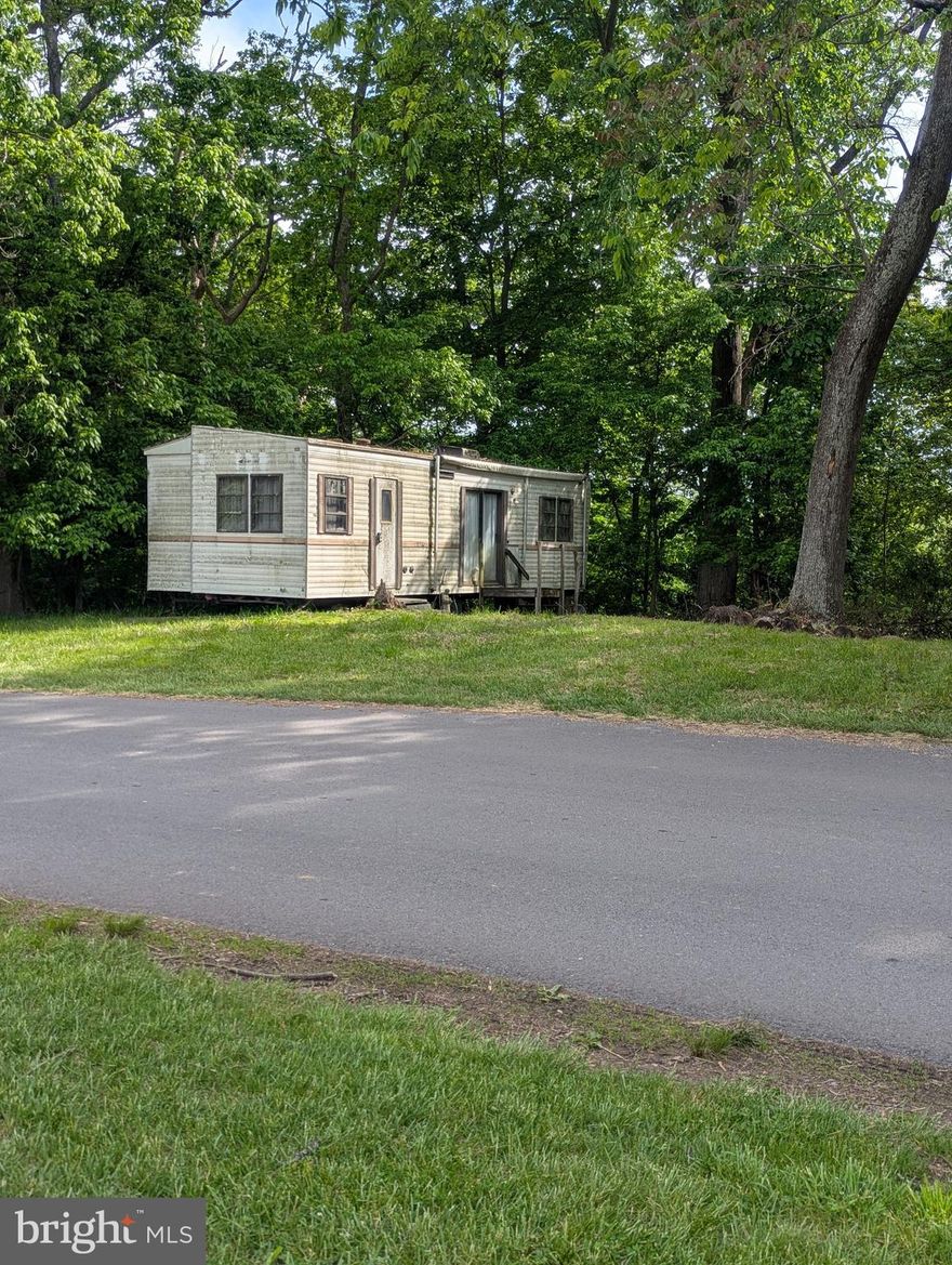 Lot is being Sold "AS IS" Camper has not been lived in for several years.  Need to sign a hold harmless just to be safe.  Camper needs work done.  Lots of potential, backs to trees.  Property is within walking distance to the common grounds, pond, pool, camp store.  Property is situated across from the open common grounds where most events are held.  Great lot to make your own. Block 78 Lot 67 is also for sale.  You can have two lots right next to one another.   

This is a gated community so you need to enter at the guard shack. Entry is not permitted without ID per the office rules. Bring ID's to the office or guard shack for visitor pass. THIS IS A SEASONAL CAMPGROUND! OPEN FROM APRIL 1 TO NOVEMBER 1. ** WELCOME TO RIVER BEND/SEASONAL LOT AVAILABLE TURN KEY** River Bend is a privately owned 400 acre recreational- vehicle camp resort with seasonal activities for members, families and guests. This great RV park is tucked away on the Upper Potomac River of West Virginia, River Bend is one of West Virginia's most popular family seasonal destinations. . Just a short drive from the Washington and Baltimore metro area. Open with utilities from April 1 to November 1. Lot owners have access to their property the entire year. *** Members Enjoy *** * Amazing views and wildlife, Potomac River access, Trails, Swimming pools, Mini-Golf, Youth center, Tennis and basketball courts, laundry facilities, convenience store, deli and lounge. *Bath houses through out the park, boat ramp, bar and grill and even a church located on the grounds. River Bend also hosts numerous activities such as 4th of July fire works, small carnival, bonfires, poker runs, horse shoe tournaments, car show, Halloween Trick or Treat and so much more.