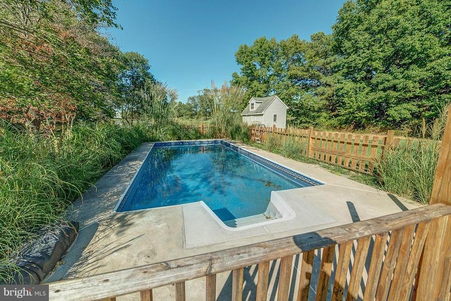 HURRY this home won't last long! Amazing home in Tower Gardens on the Bay,offers a gorgeous com. beach/boat ramp. This 4 BR 3 BA waterfront home has 2 master br's. Includes a great kitchen,S/S appliances,NEW pool liner,filtration system,pier & more! Bring your swimsuit & desire for fun! Everything is here at your fingertips w/yrs of wonderful memories to be made. Just waiting for you, don't delay!