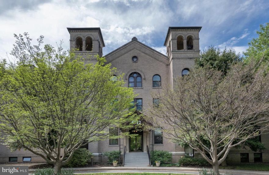 Set within an architecturally significant 1926 building originally constructed as the Convent and Chapel of the Sisters of the Visitation, this corner unit offers remarkable scale, history, and opportunity. The building features a gracious lobby and elevator access, setting an elegant tone from arrival.

The 2 bedroom, 2 bathroom unit showcases soaring ceilings, beautiful proportions, and exceptional natural light. The large kitchen opens to the dining area and overlooks the expansive living room, creating a layout that feels open and inviting. Sliding glass doors off the living room lead to a front balcony, extending the living space outdoors.

The primary suite includes a walk-in closet or dressing area, an en suite bathroom, and direct access to a second expansive balcony. A second full bathroom is located off the hallway, easily accessible from the main living areas and conveniently situated near the second bedroom, which is currently configured as a study and can easily be converted back to a true bedroom. Addtionally, this home has an in unit washer and dryer.

Offered strictly as is, the price reflects the opportunity to refresh and personalize a home with exceptional bones, beautiful scale, and a setting that feels lush, quiet, and refined. A truly special offering for a buyer who appreciates character, scale, and enduring architecture.