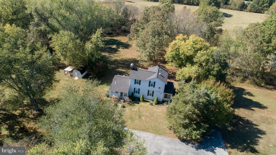 Historical Farmhouse on 5 acres, beautiful setting of land with mature trees throughout property. This unique home has been updated over the years to include 9" ceilings, central AC/Heat, newer windows , new roof on home & garage in 2018, deep well installed in 2000. Detached garage, shed and chicken coup on grounds. NO HOA and just outside Town of La Plata, no town taxes. 1 year home warranty for buyer