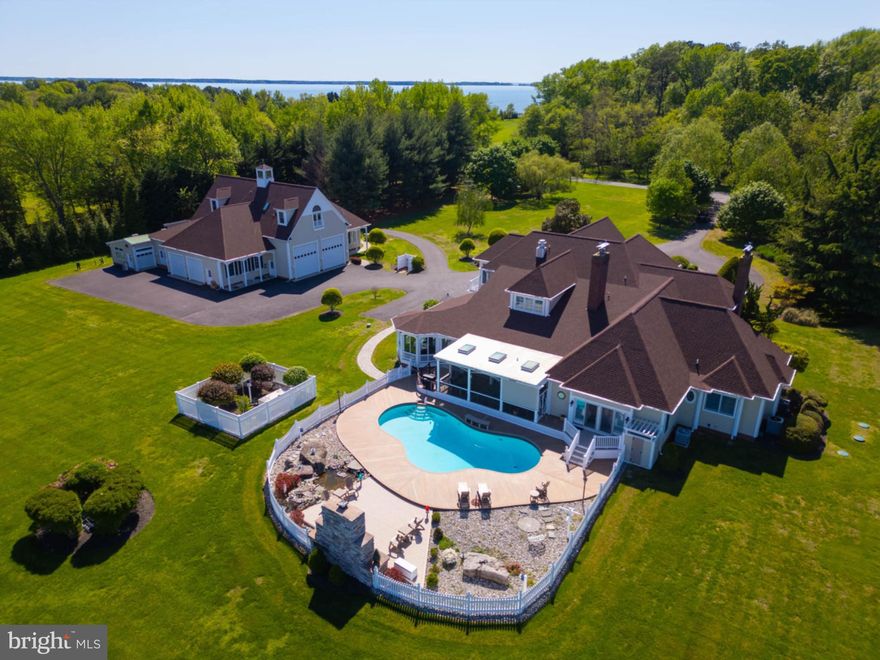 Reduced below replacement cost!!  This spectacular 5-1/2 acre, deep water Wye River estate has so much to offer that it's almost hard to know where to start. Designed and built by a family of custom home builders, the attention to detail and regular care exhibited over time will impress the most discriminating buyer. The main house was built for people that LOVED to entertain. The open floor plan invites everyone to pitch in and then carry meals to a sunny enclosed sunroom or back onto an awesome screened porch that overlooks a custom concrete pool with a stone outdoor fireplace. You'll be impressed with the kitchen as well with its high quality appliances and enormous butler's pantry. Like to craft? Then you'll find your dream craft room that shares space with a wonderful laundry room. The impressive entry leads to a more formal part of the home with a stunning formal dining room and a clubby den with its own gas fireplace. Beyond those rooms is a 1st floor main suite with an impressive dressing room for the lovers of clothing and accessories, a lovely main bath and ultimately, a breathtaking view of the Wye River. From the main suite, you can step out to the backyard pool or into the sun room.  Upstairs are 4 additional spacious bedrooms and 3 bathrooms. One of the most luxurious guest suites has a river view that is sure to captivate your guests. One is oversized and more private with its own entrance through the three car garage, perfect for staff.  Across the paved driveway is the building that makes this home particularly unique - a massive garage and shop sized to fit the largest RVs and boats. If you LOVE big garages, this one is for you! When your boats aren't stored indoors, the dock has two lifts and ample water depth to dock a substantial yacht. Got RV friends that like to visit? There is a dedicated RV pad with water, electric and sewer hookups. If longer term visits are in your mind, there is an awesome guest apartment above the garage that offers Wye River views that will have them talking long after they leave. Please allow ample time to visit this home. There is no shortage of wonderful things to see.