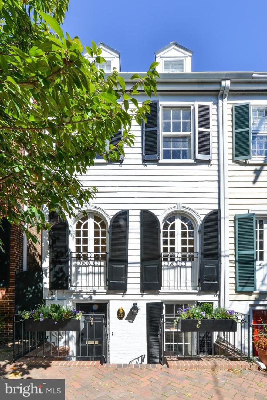 Charm, space & location combine in expanded historic TH w/Juliet balconies. Over 3000sqft on 4 levels includes large family room w/Palladian window & fireplace overlooking gardens w/insulated+heated outbuilding. Updated KIT plus elegant formal living & dining rooms. Original wood floors, high ceilings, lots of light! 1 block to park & Safeway, 2 blocks to River, 4 blocks to King St. We're in love!