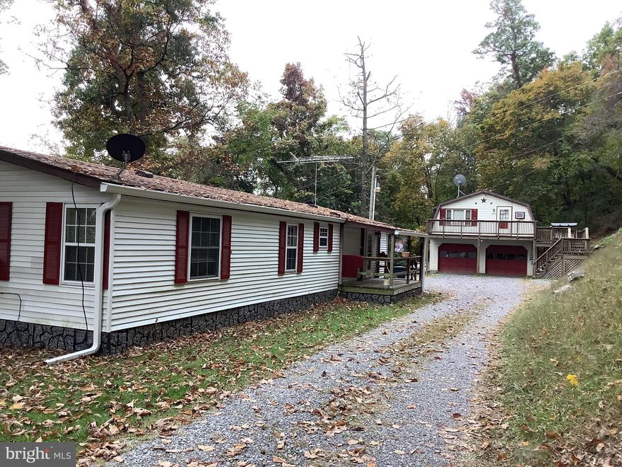 Property consists of a 3 bedroom, 1.5 Bath Double Wide with front and back deck. Situated on approx 6.51 acres. Scenic Views from the mountain looking across Martinsburg!  Property also has a detached 28
x30 2 Car detached Garage with a 2 Bedroom 1 Bath Apartment.  
This property is ready for the investor looking for rental property or a multi -family living space.