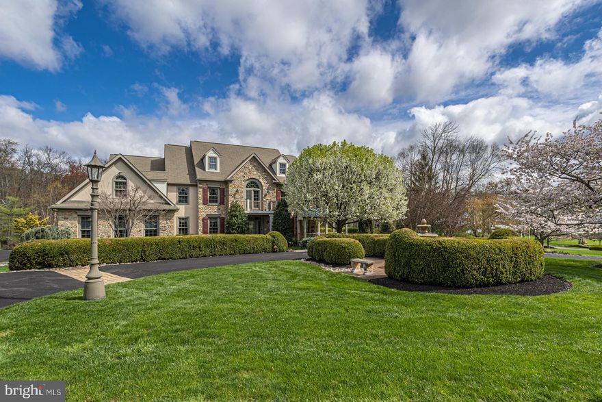 Located within walking distance to Peddler’s Village, this gorgeous custom Zaveta built home is the perfect blend of sophistication, style and craftsmanship. Starting with the governor’s driveway leading to blue stone walkway, enter through the welcoming front door into a magnificent two-story foyer adorned with a curved staircase with hand forged wrought iron rails, exquisite moldings and millwork and hardwood floors. Formal rooms fan from the foyer, with a bright and spacious living room and an elegant dining room with an amazing and spacious butler’s pantry that provides the extra space you need when entertaining. A cozy study offers privacy with French doors, built-ins, a private bar area and access to the private wrap around porch. The two story octagonal shaped gathering room features a stone fireplace and a wall of windows overlooking the spectacular rear yard. The gourmet kitchen is bright and open boasting an oversized granite island with plenty of seating, GE Monogram refrigerator, Viking double wall ovens, Viking cooktop and a stone accent wall. The light drenched breakfast area is open and airy with skylights, views of the pool and French doors leading to the incredible backyard space. Natural light and great architectural accents like fluted columns, transoms and thoughtful art nooks fill every room of this home. Head upstairs by either the main or rear staircase and you are greeted by an expansive hallway overlooking the foyer and gathering room. Enter through double doors to the private main retreat boasting a tray ceiling, window seats, 2 massive walk-in closets with organizers and a spacious sitting room with French doors leading to a private balcony. Relax and unwind in the luxurious bath with a Jacuzzi tub, oversized shower and dual vanities. Located off the main suite is a bonus room which can be used as a dream closet/dressing area, nursery or office. Completing the upstairs are 3 large bedrooms all with vaulted ceilings and walk-in closets with organizers. One bedroom has its own private bath and the other two share a Jack and Jill bath. The fully finished expansive walk-out lower level is utterly amazing and offers multiple entertainment spaces starting with a theater room, dining area, bar, billiards/game space, media area and a full bath. Walk out through French doors to an outdoor wonderland featuring a built-in grill, multiple seating areas, stone seating walls, lush landscaping and meandering walkways leading to the pool and hot tub and secluded sitting area with fireplace. Additional amenities include a 3 car garage, home generator and a central vacuum system.  All of this in the prestigious Stone Ridge development in Buckingham Township. A quick drive to both New Hope and Doylestown Boroughs for shopping and dining. Award-winning Central Bucks School District. A magnificent opportunity!