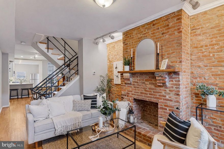 Gigantic Federal Hill Townhome with Skyline & Stadium Views

Welcome to this truly impressive four-level townhome located in the heart of Federal Hill, offering one of the highest, most jaw-dropping panoramic views of the Baltimore city skyline and stadiums from a spectacular rooftop deck.

The home features original hardwood flooring throughout, beautifully preserved historic floors on the upper levels, complemented by brand-new hardwood flooring on the main level, seamlessly blending classic charm with modern updates.

The main level is designed for both everyday living and entertaining, featuring a spacious living room, dining area, and newly renovated kitchen. The kitchen is a showstopper with white granite countertops, stainless steel appliances, exposed brick accents, and a beautiful brick fireplace that adds warmth and character. Just off the kitchen, step out onto a private deck that leads down to a rear patio, perfect for outdoor dining or relaxing.

The second level offers two generously sized bedrooms and a full bathroom accessed from the hallway, providing comfortable accommodations for guests or family.

On the third level, you’ll find a huge primary bedroom, a full bathroom off the hall, and a bonus office or flex space that opens directly onto the rooftop deck—the ultimate retreat with breathtaking, unobstructed views that make this home truly unforgettable.

The brand-new finished basement expands the living space even further, featuring a large storage/utility room and a separate bedroom or den with its own full bathroom, ideal for guests, a home gym, or additional living space.

This exceptional Federal Hill townhome combines historic character, modern finishes, expansive living space, and unmatched views—a rare opportunity in one of Baltimore’s most sought-after neighborhoods.