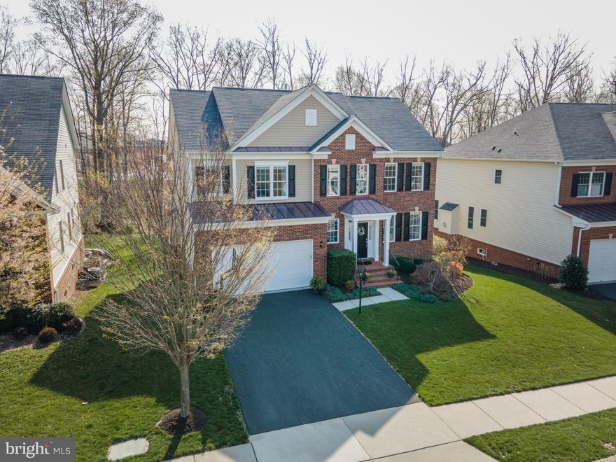 **Open House on Sunday 4/18/2021 has been cancelled.** Welcome to this absolutely magnificent property that sits on one of THE BEST lots in all of sought after Brambleton, backing to a private oasis complete with Trex deck and custom lighting, level back yard, babbling brook and mature trees... an absolute slice of heaven! This beautiful, Winchester built-home boast over 4,400 square feet of stunning living space on three finished levels and is one of the only homes in the community with a rare, full walk-out basement. Additional outstanding features of this home include solid hardwood floors throughout the main level, stairwell, upper level landing and Primary Bedroom; 9' ceilings on the main AND lower levels; stunning luxury vinyl  floors with a wood look in the lower level; upgraded Karastan carpet in all upper level secondary Bedrooms; find peaceful retreat in the Primary Bedroom with double entry, walk-in closet, detailed Tray ceiling, and En-Suite Bath with dual sink vanity, oversized soaking tub, shower, and private water closet; upper level Laundry Room with dual entry access (from the hallway and Primary Bedroom) with extra space for a folding table or hanging racks to keep you organized; Gourmet Kitchen with newly  sealed granite counters, island, Breakfast Room, and stainless steel appliances included a double wall oven (top is convection), 5-burner gas cooktop, and Zephyr commercial grade range hood; bright and open Family Room with 16'x4' bump-out, cozy, floor-to-ceiling, stone fireplace; fully finished walk-out basement with Game/Rec Room, 5th Bedroom with an enormous walk-in closet, full Bathroom, and abundance of storage space in the utility room; new sleek Quartz counters, light fixtures and mirrors in all of the Bathrooms; exquisite mouldings in the Living and Dining Rooms; Mud-Room with storage hangers provides access to and from the 2-car garage with epoxy coated flooring and storage shelving; built-in alarm system is also wired to the smoke and carbon monoxide alarms; 5-zone in-ground irrigation system; custom true-wood blinds throughout; all decorative windows feature UV protection; 6 ceiling fans - one for every Bedroom!; 2-zone HVAC has been serviced twice a year since the home was purchased. Make this dream home YOUR new home today!