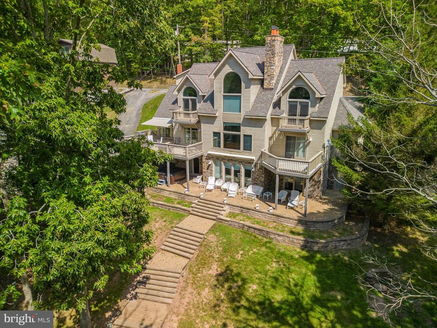 Beautifully remodeled 5 bedroom 6 and a half bath lakefront home!!!! This home sits on 100 feet of perfect lakefront. It has 5 suits style bedrooms. Each with their own full private bathroom. Tucked back  off the main lake just enough to enjoy the waterfront with low boat traffic. It is currently in the rental pool under " Lakeshore livin".  When you're not enjoying the beautiful lakefront, you can take in a movie in the private theater or spend some time in the game room!!! This home is minutes away from all Deep Creek Activities!!! House is offered turnkey, so you won't miss out on rental income!!!