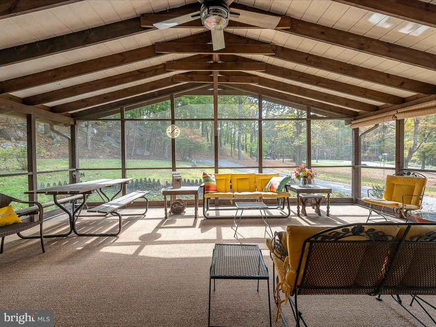 Location is everything! Quaint log cabin style rancher just up the street and around the corner from downtown Berkeley Springs!  Pretty as a picture on 2.08 acres featuring a 500 sq ft screened in porch for entertaining with an outdoor stone fireplace to cook in!  What a great space to use 3 seasons of the year! This cozy  3 bedrooms, 1 bath home boasts dual sided electric heater stone fireplace in the living room and everything needed for one level living all on public water and private septic.  Updates include: new roof & new flooring in 2022, some new lighting.  Crawl space is updated, lighted, with new plastic & dehumidifier. UNRESTRICTED-perfect for short term rentals too!  So convenient to shopping, dining, breweries & spas as well as all the amenities in Berkeley Springs State Park and just 10 miles to Cacapon State Park for golfing, boating, hiking, horseback riding, biking trails!