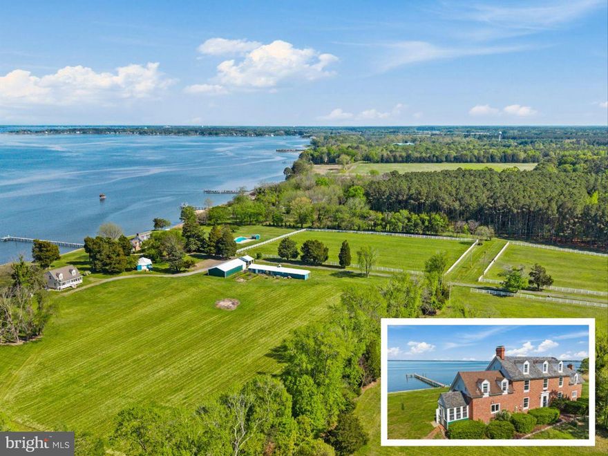 Privately tucked along the scenic Choptank River, this stately brick colonial is a rare waterfront estate offering elegance, tranquility, and over 20 acres of versatile living. A long, tree-lined driveway winds past partially fenced pasture and a collection of impressive outbuildings before being greeted by the historic main residence, where timeless charm and modern comforts await. Every room along the back of the home captures serene water views, creating a peaceful rhythm that flows from space to space. The foyer welcomes with original butterfly plank flooring, built-in bookcase, wainscoting, and a powder room. A door just beyond opens to the sweeping back patio that runs the majority of the length of the house, with its proud columns reaching high, perfectly positioned for watching boats drift by or eagles soar above the river. To the right, the generous living room features a fireplace with classic brick detailing and windows framing the glimmering water. To the left of the foyer, the formal dining room exudes grace, anchored by another distinguished fireplace and that same breathtaking view. Continue on to the kitchen, where a four-panel sliding glass door makes for a seamless transition between indoor and outdoor living. A third fireplace warms the casual dining area, while views of the water make even the simplest moments feel special. Just off the kitchen, the light-filled mud room offers walls of windows, built-ins, and a side entrance ideal for daily routines. Two staircases, one near the foyer and the other off the kitchen, lead to the home’s upper levels. On the first upper level, the primary suite features an en-suite bath with a window perfectly placed to take in views of the pier and sparkling river. Two additional bedrooms each enjoy attached full baths, one of them enhanced by its own fireplace. The second upper level adds two more bedrooms with water views and a shared full bath in between. Beyond the main residence, a charming cape cod guest house extends the property’s appeal. The main level features a bedroom, full bath, living room with fireplace, kitchen, dining area, and a sunroom overlooking the water. The upper level remains unfinished, offering space to customize or expand. The front porch runs the length of the guest house, and the back deck provides yet another outdoor entertainment space, perfect for taking in serene views of the Choptank. The estate’s outdoor amenities are equally impressive. A 30’x60’ barn with soaring ceiling offers event potential, perfect for wedding receptions or festive gatherings. It is also an ideal space to house RVs, UTVs, small boats and other high value recreational vehicles and equipment. A second barn with lean-to, six stall stable with two tack rooms, detached garage, and open pasture provide excellent potential for horse lovers or hobby farmers.  Recreation abounds with an in-ground pool and pool house, a half-court basketball area, and over 230 feet of pier and dock reaching into the Choptank, ideal for fishing, boating, or nature watching. Wildlife is abundant, bald eagles are often seen perching at the end of the pier, ospreys soar high above as the king of the skies and herons and deer, along with a variety of waterfowl make regular appearances, adding even more magic to each moment spent outdoors. As the day winds down, take in dramatic sunsets over the water, best enjoyed from the back patio, the pier, or anywhere the view opens wide to the horizon. Riprap and bulkheading protect the shoreline. This estate is just minutes from Blackwater National Wildlife Refuge, the Harriet Tubman Underground Railroad State Park, and the Horn Point Laboratory. Enjoy downtown Cambridge with its historic Main Street, vibrant cultural scene, local eateries, and year-round community events like art walks and seasonal festivals. With a rare blend of history, nature, and opportunity, this waterfront haven is poised to become your most extraordinary legacy.