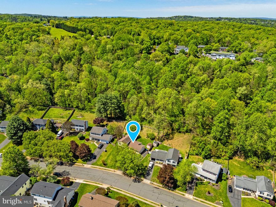 Welcome to this beautifully maintained single-family home in Leesburg, VA, ideally located on a quiet cul-de-sac with low traffic in the highly desirable Leesburg Country Club neighborhood (no HOA). This home offers a rare combination of privacy, mature landscaping, and convenient access to parks, downtown Leesburg, and commuter routes.  ****  The property features a private, fully fenced backyard backing to a scenic hillside and mature trees, creating a peaceful, natural setting perfect for relaxing, entertaining, or enjoying outdoor living. The front yard showcases established landscaping with mature flowering trees, enhancing curb appeal throughout the seasons. **** Just a few homes down the street, you’ll find direct access to Westpark, a 134-acre county-owned passive park with walking trails, open green space, and nature areas—ideal for walking, jogging, dog walking, birdwatching, and enjoying the outdoors. This location offers a unique lifestyle opportunity rarely found in town. All of this is just a 5-minute drive to Historic Downtown Leesburg, known for its restaurants, shops, events, and charm. Inside, the home is in excellent, move-in ready condition with thoughtful updates throughout. The upgraded kitchen features Corian countertops, a movable center island with granite top, and stainless steel appliances, providing both function and flexibility for everyday living and entertaining. **** The main level and lower-level family room offer durable and stylish luxury vinyl plank (LVP) flooring, while the bedrooms are carpeted. The walkout lower level opens directly to a beautiful slate patio, creating seamless indoor-outdoor flow and additional space for gatherings or quiet enjoyment. **** Additional features include a backyard shed, extra storage above the garage, an attached garage, and extensive driveway parking, providing plenty of room for multiple vehicles and guests. **** Enjoy the benefits of public utilities and town services, including road and sidewalk maintenance, trash service, yard waste pickup, and snow removal—all without the cost or restrictions of an HOA. **** This home offers an exceptional combination of location, condition, outdoor space, and lifestyle, making it a standout opportunity in the Leesburg market. Open House Sunday, April 26th 12-3:00