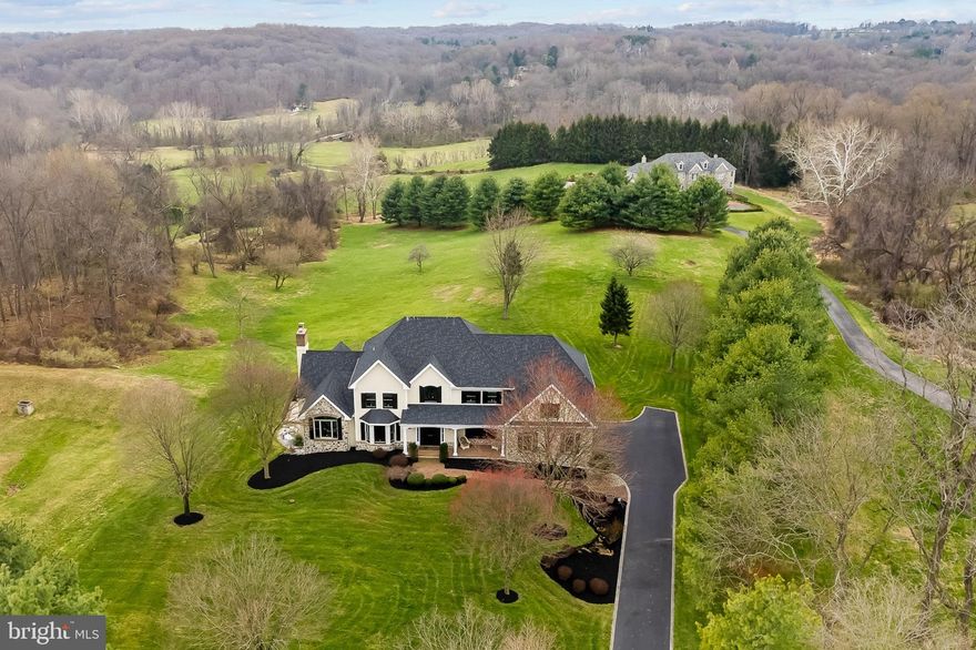 This magnificent home rests on a serene 5.7 acre lot adjacent to the White Clay Creek Preserve  The home is positioned to take full advantage of the incredible views overlooking the beautiful rolling hills of Southern Chester County.  Fine workmanship and keen attention to detail went into each and every area creating eye-catching details that set this property apart. Immediately, visitors feel a sense of expansiveness, beginning with the two-story foyer which features a dramatic turned staircase with balconies. Architectural elements including arched doorways, stately pillars, and elegant moldings link the spacious rooms. Spend time with family and friends in the inviting family room with vaulted ceilings, walls of windows, and gorgeous stone raised-hearth fireplace. Cooks will love the 6-burner JennAir gas cook-top, JennAir double wall ovens, Sub-Zero refrigerator, and large center island. Completing the main level is a private study with built-ins, formal living and dining rooms, laundry room with chute, and an oversized 3-car garage with epoxy flooring. The upper level is outfitted with gorgeous Brazilian Cherry hardwood flooring. The owner’s suite is sumptuous space with glass doors that open to a private porch, two large walk-in closets, and a luxurious renovated bathroom boasting a double vanity, seamless glass tile shower and separate soaking tub. The three additional bedrooms are all generously sized with good closet space. The daylight lower level is comprised of a wet-bar, recreation area, secondary family room, exercise room, 5th bedroom, and full bath, offering versatile living spaces that can accommodate a variety of needs. A raised Trex deck connects the main level of the home to the patio and salt-water pool. The backyard is an absolute oasis, with breathtaking views from each and every angle. Surrounded by Landenberg's stunning landscape, Country Walk remains one of the area’s most prized communities and this home is a jewel in its crown. *Numerous updates include all new HardieBoard siding in stalled in 2021; all new Anderson windows installed in 2021; new roof, gutters, and downspouts in 2021; new alarm system—WiFi windows and doors in 2021; new shutters and exterior lights in 2021; new epoxy finish garage floors in 2021; new pool surface and travertine tile.