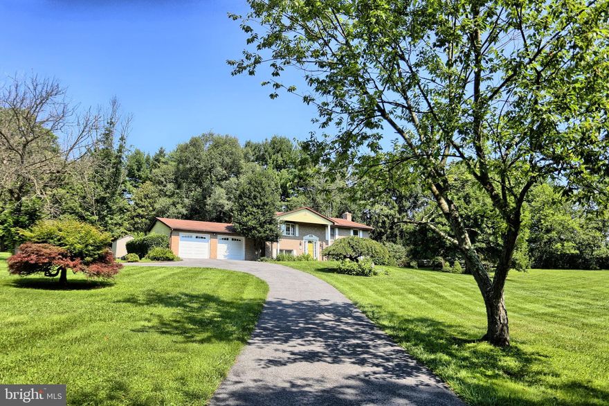 Welcome home to this magnificent home offering four bedrooms, light filled interiors and tucked away in the private setting you have always dreamed of! Beautiful landscaped grounds welcome you as you arrive. Boasting a neutral color palette, sun drenched windows and thoughtful details throughout. Kick your feet up and relax in the sun drenched living room adjacent to the dining room, making modern living and entertaining easy. Prepare chef inspired meals in the Country kitchen with a breakfast nook for a table and ample counter space and storage. Retreat to the primary bedroom suite with a secluded bathroom offering a private tub/shower. Two additional bedrooms and a second full bathroom complete the upper level. Lounge and unwind in the sizable recreation room complete with a cozy  fireplace and accent brick wall. The fourth bedroom in the lower level offers a separate suite with a half bathroom on the lower level. You'll have plenty of room in the  attached oversized 2 car garage!  Enjoy time outside in the massive yard with a  lot backing to trees on 2.2  acres.