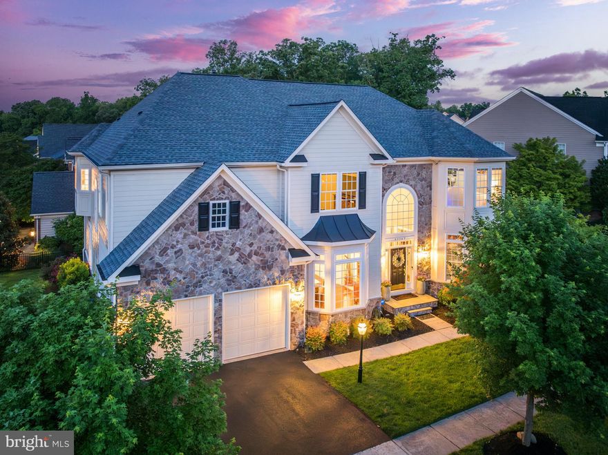 Prepare to be enchanted by this luxurious and beautifully upgraded home in the sought-after community of Lansdowne on the Potomac. This Huntley Model showcases generous formal and open-concept living areas, indulgent en suite bedrooms, and prime outdoor living on 0.29 acres of meticulously landscaped grounds. As you arrive on the tree-lined streets, exterior accents of stone and towering windows hint at the grandeur within. The two-stall garage is bordered by recently updated landscaping, a peaceful respite only minutes from fabulous community amenities, schools and nearby shopping and dining. Inside, a double-height foyer and sweeping staircase make a stunning first impression, joined by a private home office and the formal dining space adorned with elegant moldings and newer hardwood floors. The heart of the home is a sweeping open-concept great room, which seamlessly flows from the living room with a floor-to-ceiling fireplace, through the gourmet eat-in kitchen, and into the family room and second stairs to bedrooms above. Cook and catch up with guests at the huge center island with generous bar seating and integrated cooktop. Home chefs will love the durable granite countertops and extensive storage, creating a kitchen that is both beautiful and functional. Host casual meals or tackle weeknight homework at the eat-in dining space, and move directly outside to the comfort of your screened-in porch, complete with ceiling fan and sun/privacy shades. The adjacent open deck space is ideal for grilling and dining under the stars. At a generous 7,000+ sq ft, the thoughtful design and quality craftsmanship of the interior maintains an inviting and relaxing atmosphere. Retreat upstairs to your palatial primary suite, where the primary bedroom features a private sitting area, dual walk-in closets, and multiple large windows inviting daylong sunlight. The decadent primary bath boasts a luxurious soaking tub, large separate shower and dual vanities with updated quartz countertops, white cabinetry, new mirrors, and fixtures. Additional upstairs bedrooms include two junior suites, each with private full bath and walk-in closet, and two large secondary bedrooms which share a jack-and-jill bath, ensuring the utmost privacy and comfort for family and guests. The laundry room with front-loading washer and dryer is also conveniently located upstairs near the bedrooms. On the lower level, discover even more flexible space to relax and entertain. This level has an additional full bath and bedroom, making a great guest suite, as well as the second powder bath to serve the huge recreation room. You'll love to entertain at the fully equipped built-in bar, and create your perfect game room, theater, gym, etc. in this versatile area. Easily move outside with a sunny French door walk-up to the yard. The lower level also includes an extensive storage space with built-in shelving and a second laundry washer and dryer. More upgrades include a newer roof in 2019;   New AC unit and ductwork in attic, return airflow, and whole house filtration system installed 2023. The property also features a complete lawn irrigation system added 2022, new outdoor faucets to front and back in 2023, replaced driveway and freshly painted front entrance in 2024, as well as upgraded lighting throughout, and new basement window treatments, all completed in 2024. The Lansdowne community is known for its amenities, including indoor and outdoor pools, a fitness center, playgrounds, canoe and kayak launch, summer concert series, sport courts and aerobics rooms, a business center, ballroom, meeting rooms, and more. All conveniently located near Route 7, shopping and dining at Lansdowne Town Center, the Golf Club at Lansdowne, Lansdowne Resort and Spa, hiking trails, and Elizabeth Mills Riverfront Park, this luxury estate offers the perfect blend of grandeur, comfort, and convenience in one of the most sought-after communities in the area.