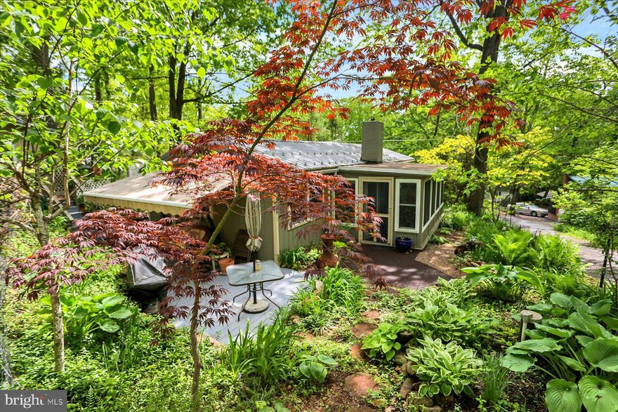 Just what you have been waiting for!! A cottage in the woods within walking distance of Cowen's Gap State Park with its beautiful lake & beach area.  Open floor plan in the kit./liv. rm./din. Nice size sun room with heat can be used year around.  Fireplace with wood/coal insert heats most of the house in the winter. Heated Guest cottage with a bedroom & sitting area & utility rm with approx. 388 sq. ft, for friends' overnight visitors! Beautiful landscaped double corner lot with walking paths!  Patio with a retractable awning to keep you cool while enjoying the outdoors. Metal roofs on the cottage & guest house.