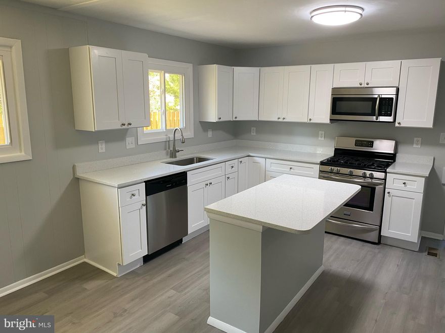 PRICE IMPROVEMENT! Beautifully updated 4 BR, 1.5 BA one level rancher in desirable Green Haven. New roof, windows, HVAC,  kitchen cabinets and quartz countertops, plus updated stainless steel appliances. The bathrooms have new vanities toilets and tub, Laundry room off kitchen has updated front loading washer and dryer. Updated vinyl flooring throughout. New fresh paint.  Re-insulated crawlspace.  House comes with a fully fenced corner lot and a 3 car driveway with additional street parking. Attached shed for lawn equipment. Shaded front lawn with a sunny  open area on the right side of the house. This amazing home is move-in ready. Priced to sell; it won't last long at this improved price!