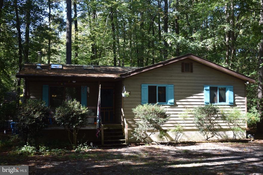 Quaint mountain cottage only 6 miles from the ocean.  Large wooded lot on cul-de-sac street with  loads of parking .   Private 12x10 rear screened in porch.  Detached shed. Covered entry porch.  Skylights on the cathedral ceiling in the great room.   It's  very nice  inside - don't miss this one, it will go fast. Make your appointment today!  Sold "as is" but home inspection is welcomed.