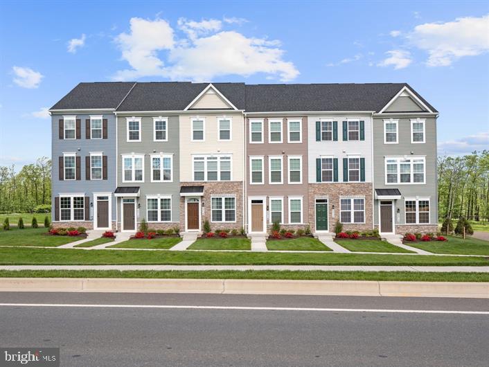 End of group, Clarendon model at Elkridge Crossing- Featuring the 4 finished levels and a deck off of the kitchen. Never has convenient townhome living felt as luxurious as it does in the Clarendon; and with so many customizing options, it's sure to fit your needs. The lower lever features a 2 car tandem garage, perfect for parking or whatever you need to store. On the main level and you'll find yourself in a welcoming and light-filled open floorplan, more spacious than you thought possible in a townhome. A gourmet kitchen creates a sense of warmth and unity, while the dining room gives a perfect place for entertaining. A huge family room can be furnished in the way that suits you best; while a large coat closet and powder room are tucked away but convenient for guests. Don't forget to add the optional deck and bring outdoor living to your home. Upstairs the feeling of space continues with a large hall foyer. The primary bedroom is an oasis and features a large shower, dual vanity, and gigantic walk-in closet. A second bedroom also features its own bath. The fourth level includes a 3rd bedroom, loft area and bath. There are optional designs to customize this 4th level for your lifestyle. Options vary by community, so you can be sure to have the home that's right for you! There are many places you can choose to build your new home. Why here? Why Elkridge Crossing? When you move to Elkridge Crossing, you're not only becoming a part of an amazing new neighborhood but you get to enjoy all the perks of living in Howard County! Top Rated Schools. You'll love the peace of mind knowing that your children are going to some of the area's best schools. Use the community walking trail for easy access to both Elkridge Elementary and Elkridge Landing Middle School and drive a few minutes down the road to Howard High School. Convenience. No matter where you work, your commute just got easier! Located off route 1, you'll have easy access to route 100, I-95, I-295, I-895 and more. With shopping and dining also close by, your life becomes less chaotic having all of your everyday conveniences within close reach. Family Fun. There are so many options available all located within minutes of our community. Head to Patapsco State Park where you can bike, hike, fish or camp. Rockburn Branch Park is also a great choice and offers miles of scenic trails, athletic fields, playgrounds, a disc golf course and a picnic pavilion! It's time to love where you live!