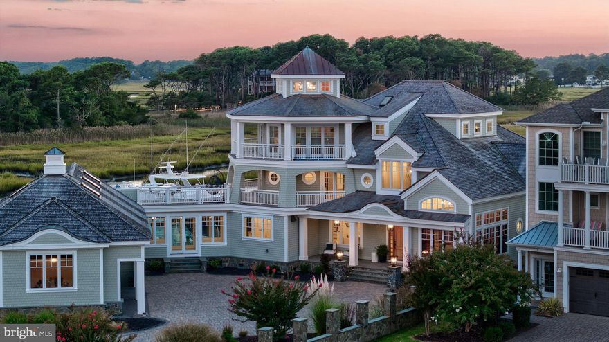 Experience refined waterfront living in this exceptional 7,350-square-foot estate in West Ocean City. Positioned with ideal southern exposure, the home captures sweeping views of Assateague Island National Park and the constant activity of the Ocean City inlet.  This custom-built residence is offered completely furnished and features six bedrooms, six full baths, and two half baths. A striking curved staircase anchors the interior, complemented by European cabinetry, expansive Pella windows and doors, and high-end finishes throughout. Radiant floor heating and geothermal systems deliver efficient, year-round comfort.
Designed for both everyday living and entertaining, the layout includes spacious gathering areas, private bedroom suites, three separate laundry areas, and a dedicated captain’s quarters.  For boaters, two rare 24-foot-wide deep-water slips provide immediate access to the harbor and open ocean—an unmatched advantage in this location.  Offered at $6.9 million, this property represents a compelling value, with an estimated replacement cost near $12 million. The quality, setting, and waterfront lifestyle offered here are simply not reproducible at this price.  A rare opportunity to own a turnkey coastal estate with premier views, direct water access, and enduring craftsmanship.