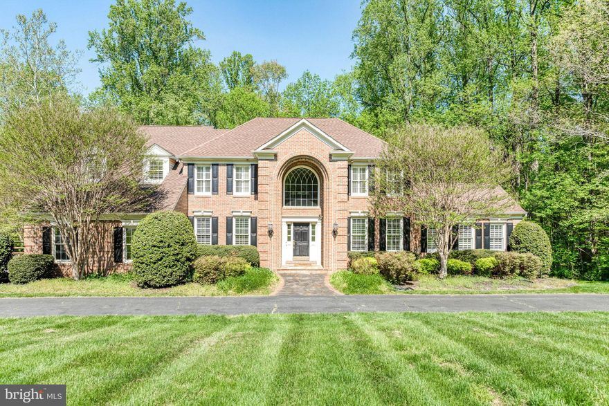 Explore the charm of Fairfax Station with this stunning home! It features a grand curved staircase leading to a two-story foyer, complemented by elegant hardwood floors. The gourmet kitchen is a culinary enthusiast’s dream, equipped with high-end stainless steel appliances, custom cabinetry, and beautiful granite countertops. On the first floor, enjoy a library with custom paneled walls and sunroom. Hardwood flooring continues throughout the upper level and primary bedroom and three additional spacious bedrooms. The basement offers two extra bedrooms, a recreational area, 2 bar areas and new carpet. This property is being sold AS-IS. Roof 2010, 1 newer HVAC, 1 new water heater.