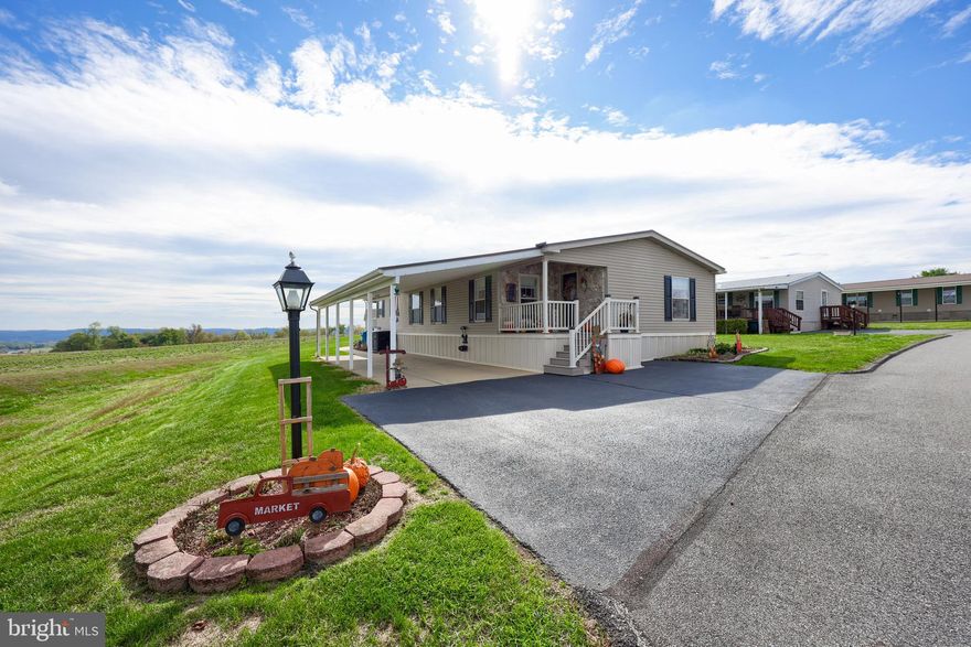 Enjoy peaceful countryside views from this beautifully maintained home situated on an oversized lot in a desirable 55+ community. Outdoor highlights include maintenance-free decks, an extra-wide carport, and a spacious storage shed—perfect for all your gardening and hobby needs. Step inside to a bright and open layout featuring luxury vinyl plank flooring throughout. Numerous updates include new flooring, lighting, roof, and decks, giving this home a truly move-in-ready appeal. The inviting living room offers a cozy gas fireplace and flows seamlessly into the kitchen and dining area—ideal for everyday living or entertaining. The kitchen features a sliding glass door that opens to the deck, where you can enjoy peaceful al fresco dining and stunning countryside views. The primary suite provides a relaxing retreat with a walk-in closet that connects conveniently to the primary bathroom, complete with a soaking tub, walk-in shower, and double vanity. Two additional bedrooms, a full bath, and a laundry room complete this functional layout. Conveniently located with easy access to Route 30 and Lancaster, this home offers both comfort and convenience in a scenic setting.