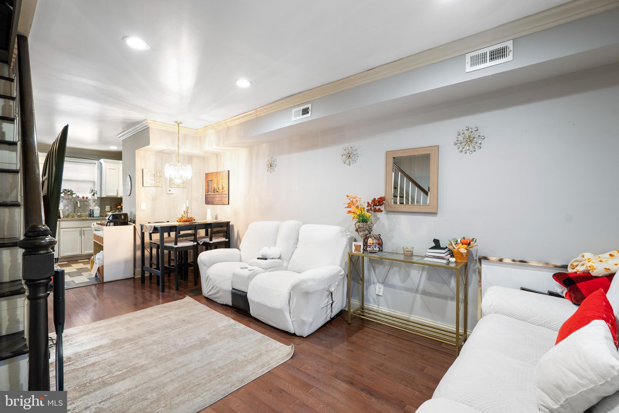 Welcome to this beautifully updated end-of-group rowhome featuring a classic covered front porch, perfect for your morning coffee or evening unwind. Step inside to find gleaming hardwood floors flowing throughout the main level. The spacious living room offers crown molding, recessed lighting, and plenty of natural light, seamlessly connecting to the dining area, ideal for entertaining. The updated kitchen boasts ample cabinetry, granite countertops, stainless steel appliances, a tile backsplash, and plenty of prep space for your favorite meals. Upstairs, the primary bedroom offers comfort and charm, joined by an additional bedroom and a full bath with a tub/shower combo. The fully finished lower level provides versatile living space with a third bedroom, a full bathroom featuring a walk-in tiled shower, and extra room for a home office or rec space. Step outside to a private backyard with a deck and fenced yard, perfect for summer BBQs and gatherings. Conveniently located near Patterson Park, Canton, and all the shops and restaurants in Brewers Hill, this home combines city living with modern comfort.