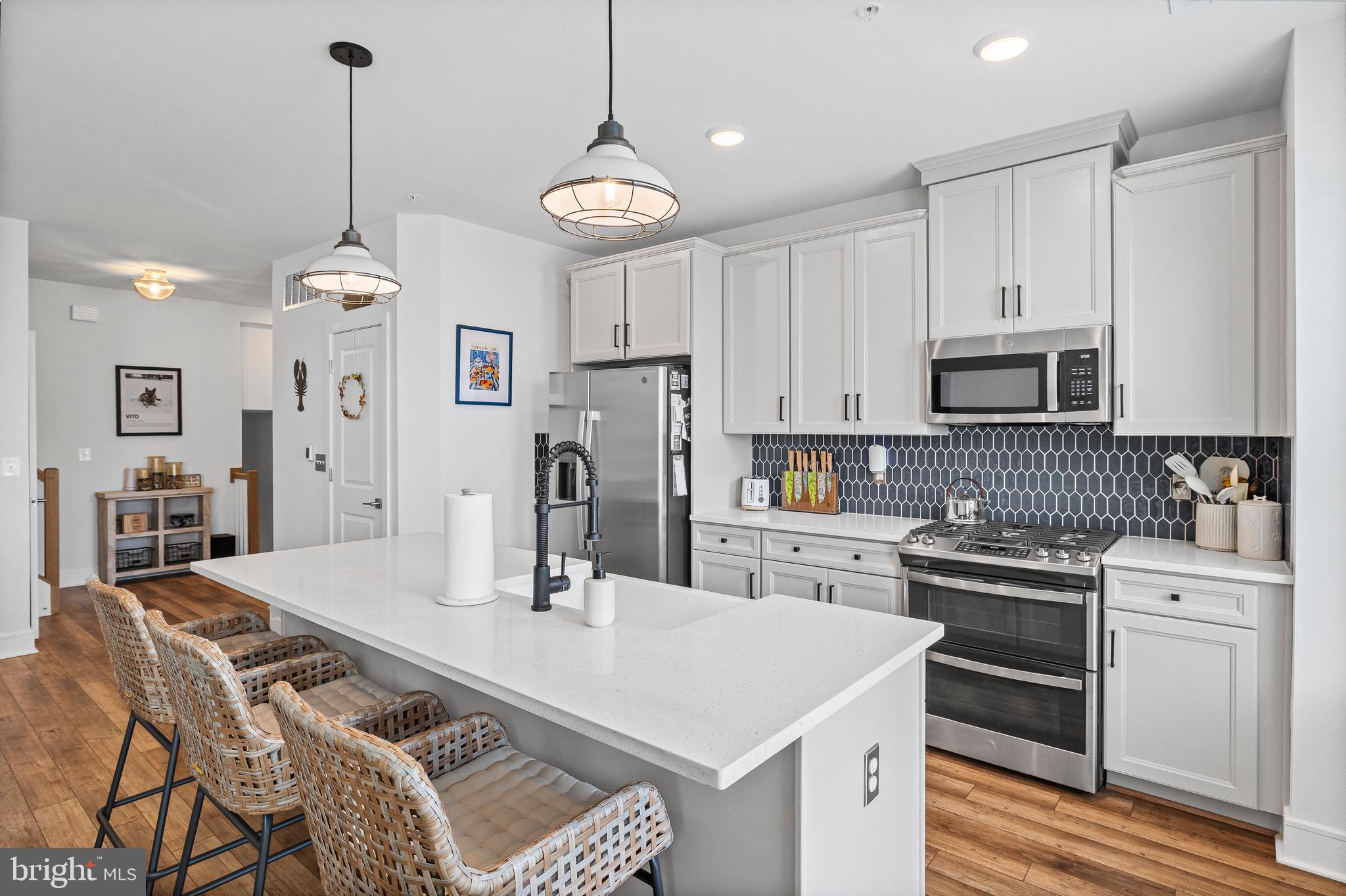 Mortgage savings may be available for buyers of this listing. Connect with listing agent for details! Welcome to 43270 Farringdon Square -- a beautifully maintained townhouse style condominium with over $30k in upgrades! With over five levels of living space this townhouse has endless possibilities. The main walk-in level has a spacious foyer that could be used as a home office or study and a large mudroom is located right off the garage for dropping off groceries with ease.
Leading up to the main living area the upgraded kitchen is spectacular featuring soft close cabinets, a double slide in range equipped with an air fryer and built-in griddle, a white farmhouse sink, and an upgraded pantry.
All bathrooms have upgraded faucets, flooring, fixtures, and comfort height toilets with quiet close lids. Three floors have upgraded luxury vinyl plank flooring with the fourth floor having carpet in 2 generously sized bedrooms. All bedrooms and the main living area are wired with CATV ports and the primary bedroom wiring was thoughtfully upgraded so outlets/TV ports would be placed up against the bathroom wall (not up against the neighbors wall) which offers both increased privacy and a huge plus for light sleepers!
In the primary ensuite you will find an upgraded custom-made tile that is absolutely gorgeous. Whether you like having a cup of coffee in the morning or sitting out under the stars, you find serenity on your very own roof deck with ample space for entertaining .
The sought-after neighborhood in Broadlands offers convenience with close proximity to the Metro Silver Line and to the Dulles airport. Other owner amenities include access to a fitness center, 3 pools, tennis courts, and several walking trails. Harris Teeter, Starbucks, and so much more in Broadlands Marketplace are within a mile, providing easy access. The HOA fee covers water, trash, exterior maintenance, and includes access to 3 swimming pools and a fitness center. This is not your ordinary, builder grade home - it’s a thoughtfully designed must see!