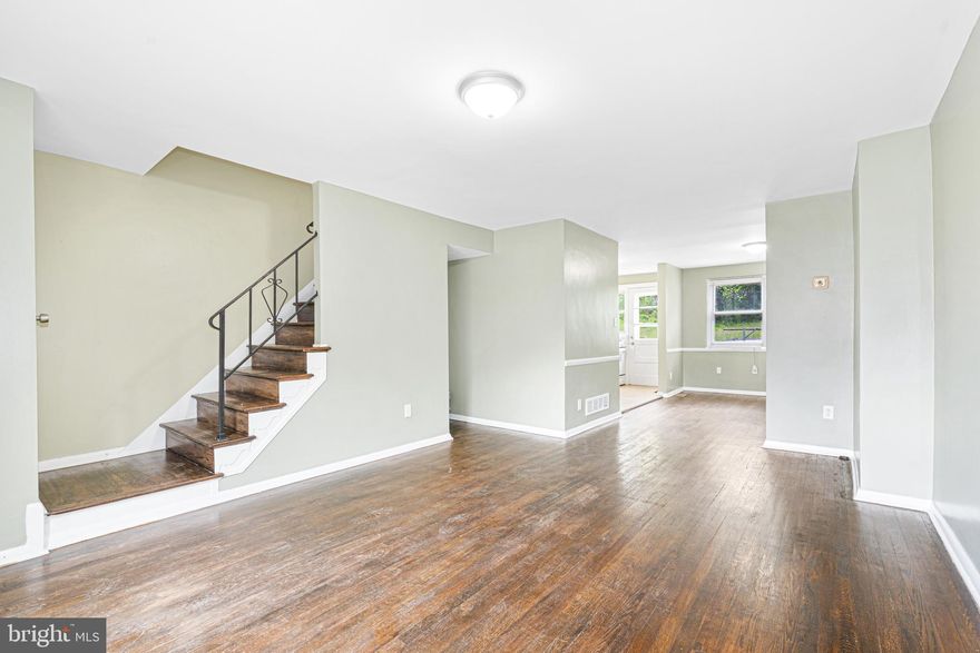 Welcome to comfort and convenience in this charming home nestled on a peaceful, no-thru street—just moments from shopping, dining, and major commuter routes. Enjoy the ease of ample parking with a private parking pad, alley access, and ample street parking. Step onto the covered front porch and enter the living room featuring beautiful hardwood floors that flow throughout the main level. The spacious dining room opens to the kitchen, which offers direct access to the backyard and private parking area—perfect for everyday convenience. Upstairs, you'll find three comfortable bedrooms, a full bath, and access to the attic.  The versatile lower level is ready for your personal touch—ideal for a family room, playroom, or home gym. Plumbing is already in place for a potential second bathroom, and the open layout offers easy access to laundry and utilities. Don't miss the opportunity to make this delightful property your new home!